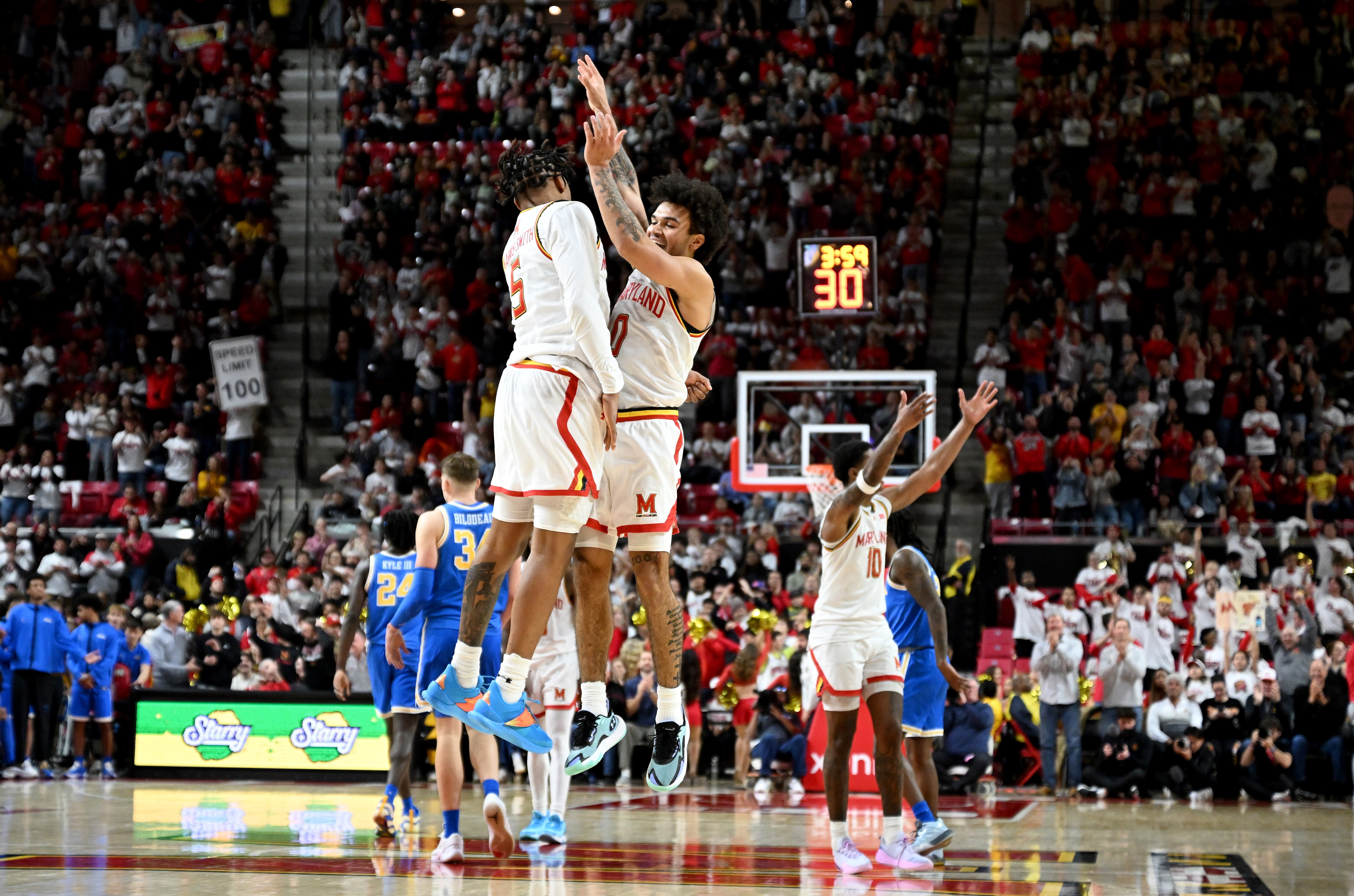 Ja’Kobi Gillespie (right) and DeShawn Harris-Smith bump chests during the second half of Maryland’s win over UCLA on Friday night.