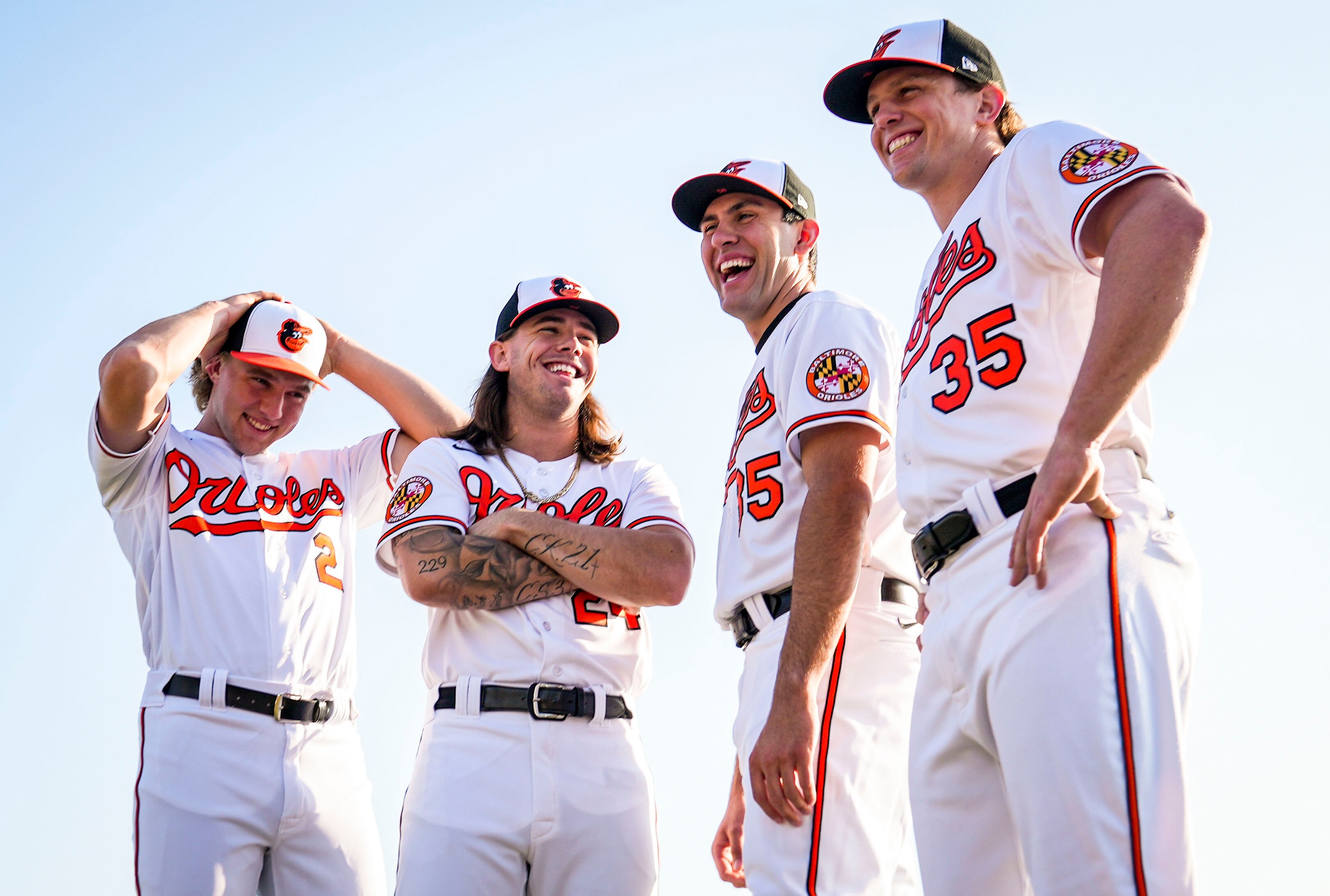 Baltimore Orioles Gunnar Henderson (2), DL Hall (24), Grayson Rodriguez (85) and Adley Rutschman (35) share a laugh after posing for a group portrait during Photo Day at Ed Smith Stadium in Sarasota on 2/23/23. The Baltimore Orioles’ Spring Training session runs from mid-February through the end of March.