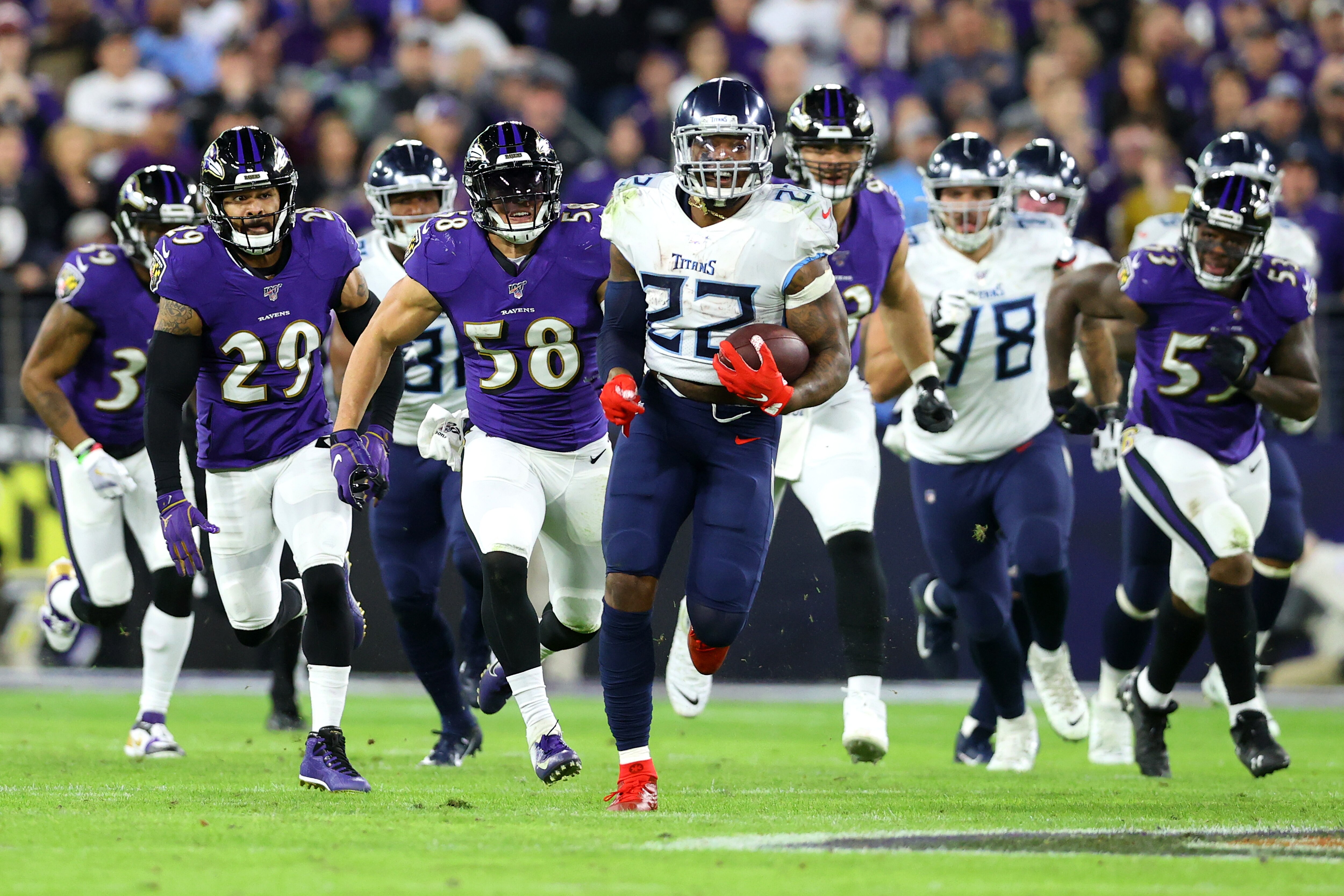 Running back Derrick Henry #22 of the Tennessee Titans carries the ball against the Baltimore Ravens during the AFC Divisional Playoff game at M&T Bank Stadium on January 11, 2020 in Baltimore, Maryland.