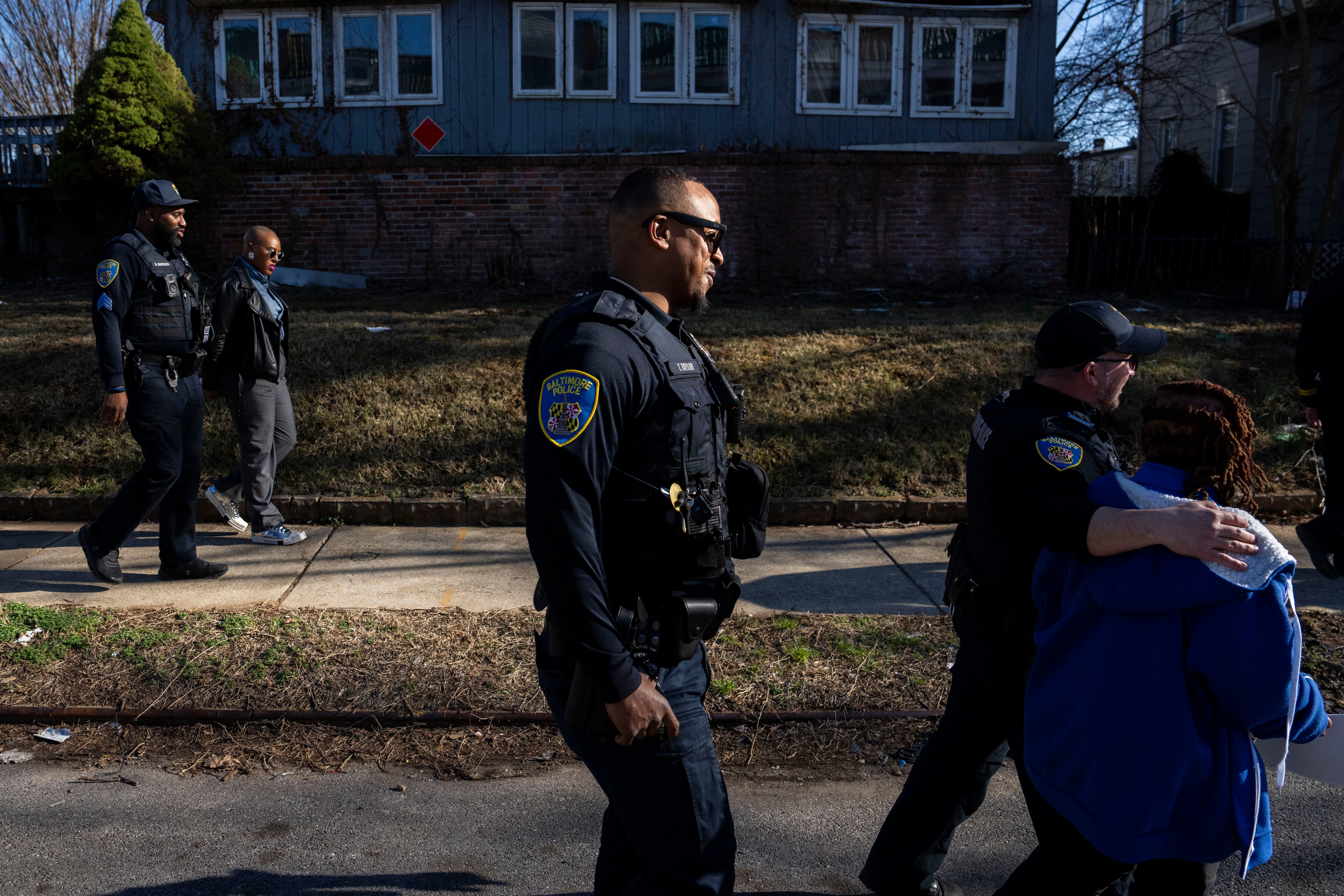 From left, officers Rashad Hamond, Terrell Taylor, and Steve Tandy on a "community walk" with community members in the Forest Park neighborhood.