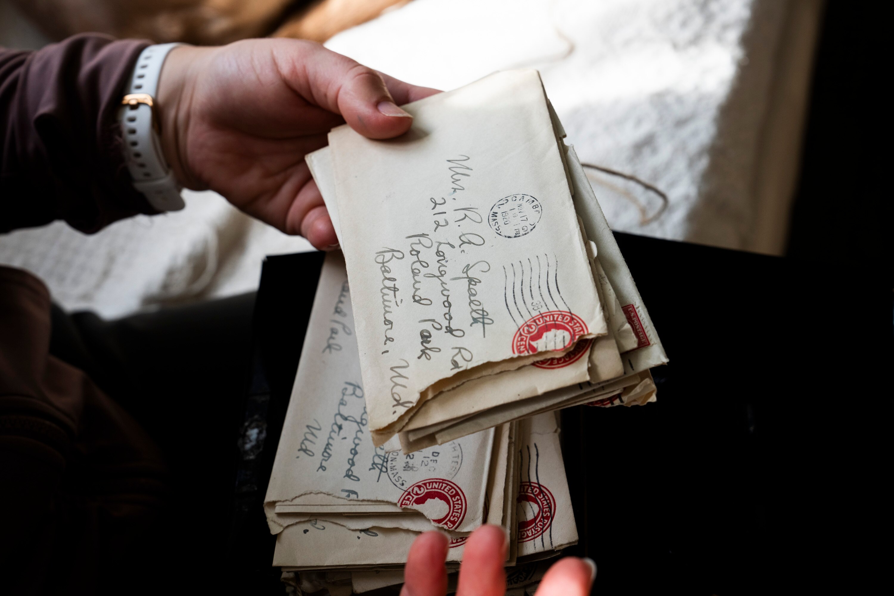 Joanna Meade reads aloud love letters from the 1920's in the sun room of her home on February 27, 2024. The letters were found inside of a wall during a renovation.