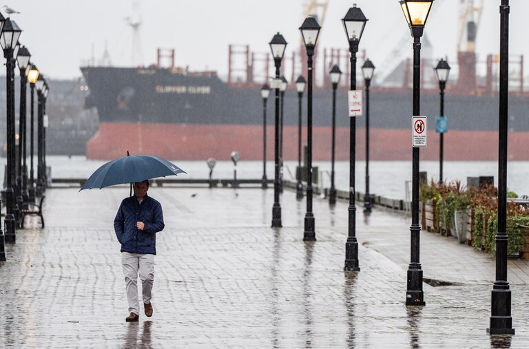 A person walks through Fells Point on a rainy Tuesday, Jan. 9, 2024.