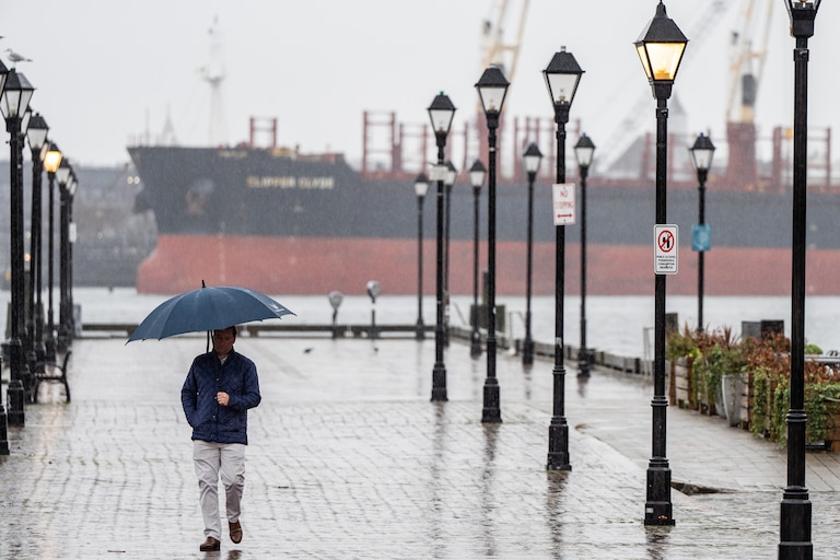 A person walks through Fells Point on a rainy Tuesday, Jan. 9, 2024.