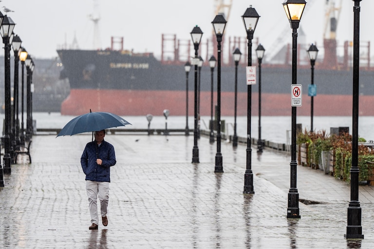 A person walks through Fells Point on a rainy Tuesday, Jan. 9, 2024.
