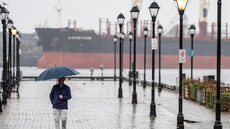 A person walks through Fells Point on a rainy Tuesday, Jan. 9, 2024.