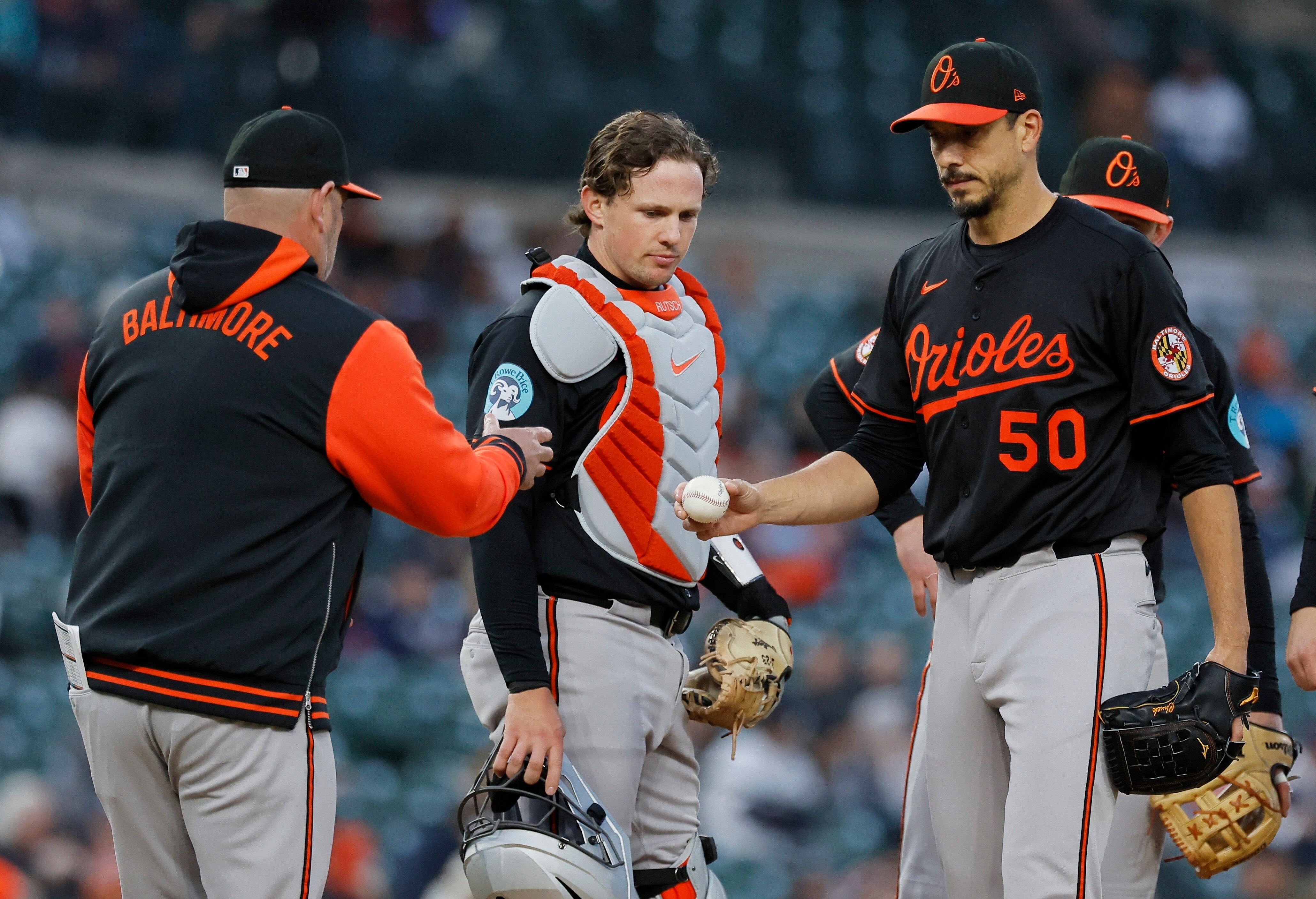 Baltimore Orioles pitcher Charlie Morton (50) gives up the baseball to manager Brandon Hyde, left, with catcher Adley Rutschman looking on, in the sixth inning during the second baseball game of a doubleheader against the Detroit Tigers Tigers Saturday, April 26, 2025, in Detroit.