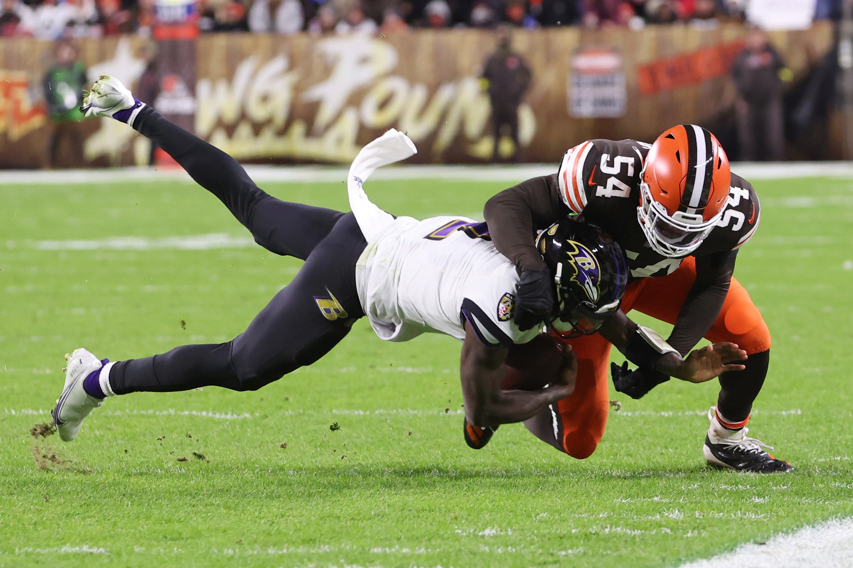 CLEVELAND, OHIO - DECEMBER 17: Tyler Huntley #2 of the Baltimore Ravens is tackled by Deion Jones #54 of the Cleveland Browns during the third quarter at FirstEnergy Stadium on December 17, 2022 in Cleveland, Ohio. (Photo by Gregory Shamus/Getty Images)