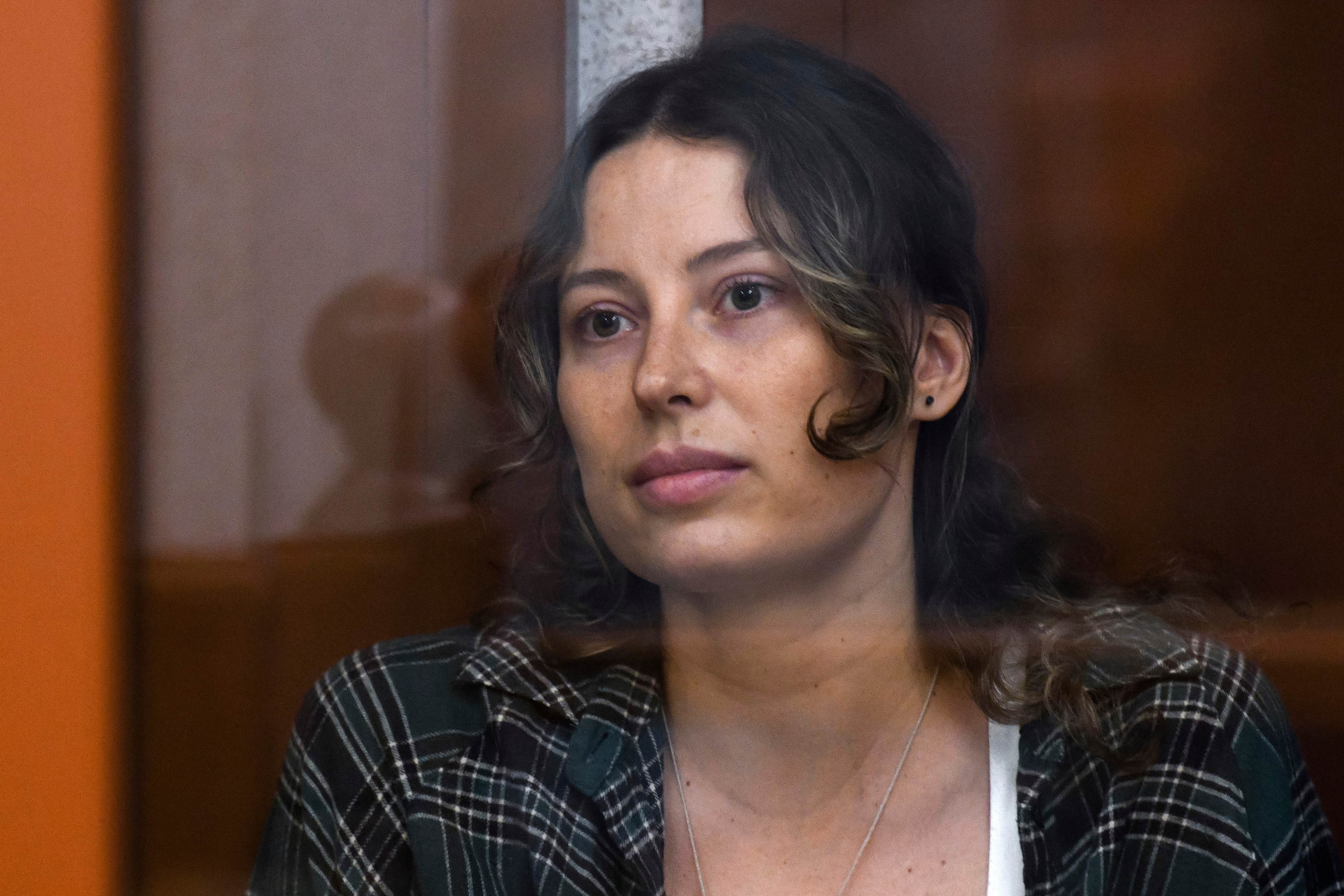 FILE - Ksenia Karelina, also known as Khavana sits in a glass cage in a court room in Yekaterinburg, Russia, Thursday, June 20, 2024. (AP Photo, File)
