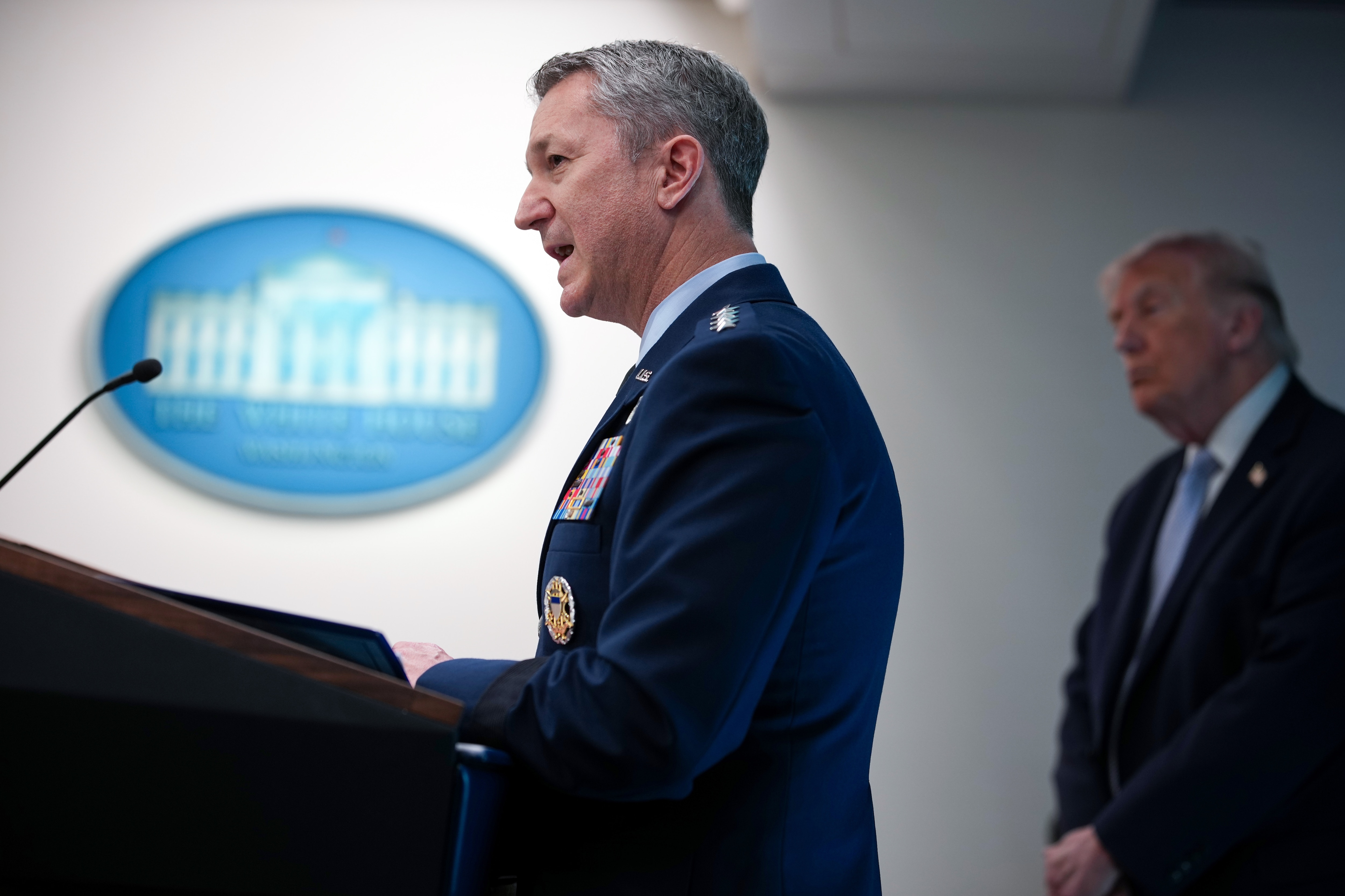 WASHINGTON, DC - APRIL 06: Chairman of the Joint Chiefs of Staff General Dan Caine speaks as U.S. President Donald Trump (R) looks on during a news conference in James S. Brady Press Briefing Room of the White House on April 06, 2026 in Washington, DC. President Trump spoke about the successful military mission to rescue a weapons systems officer whose F-15E Strike Eagle was shot down in Iran.