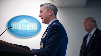 WASHINGTON, DC - APRIL 06: Chairman of the Joint Chiefs of Staff General Dan Caine speaks as U.S. President Donald Trump (R) looks on during a news conference in James S. Brady Press Briefing Room of the White House on April 06, 2026 in Washington, DC. President Trump spoke about the successful military mission to rescue a weapons systems officer whose F-15E Strike Eagle was shot down in Iran.
