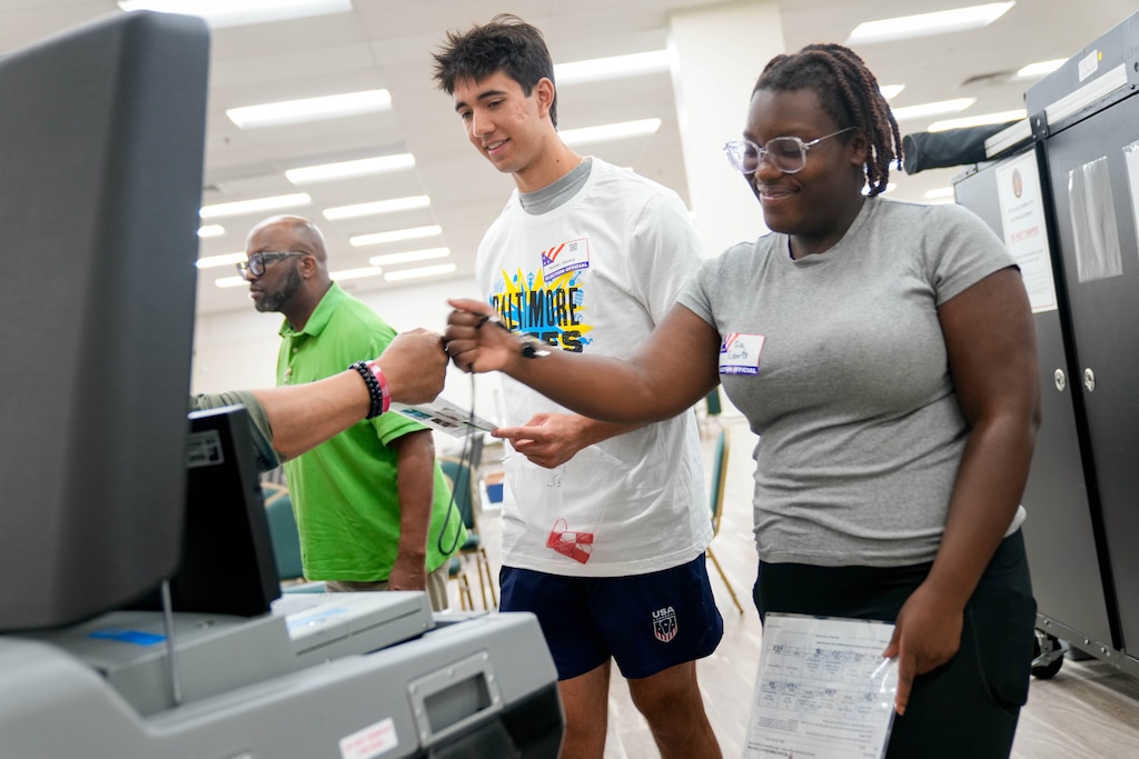 Sia Roberts, right, and Rohan Vesely are congratulated by instructor Marvin Briscoe for setting up their equipment properly during a simulated portion of a training session for election judges for the upcoming Maryland Primary Election in Baltimore, Md. on Saturday, May 30, 2026.