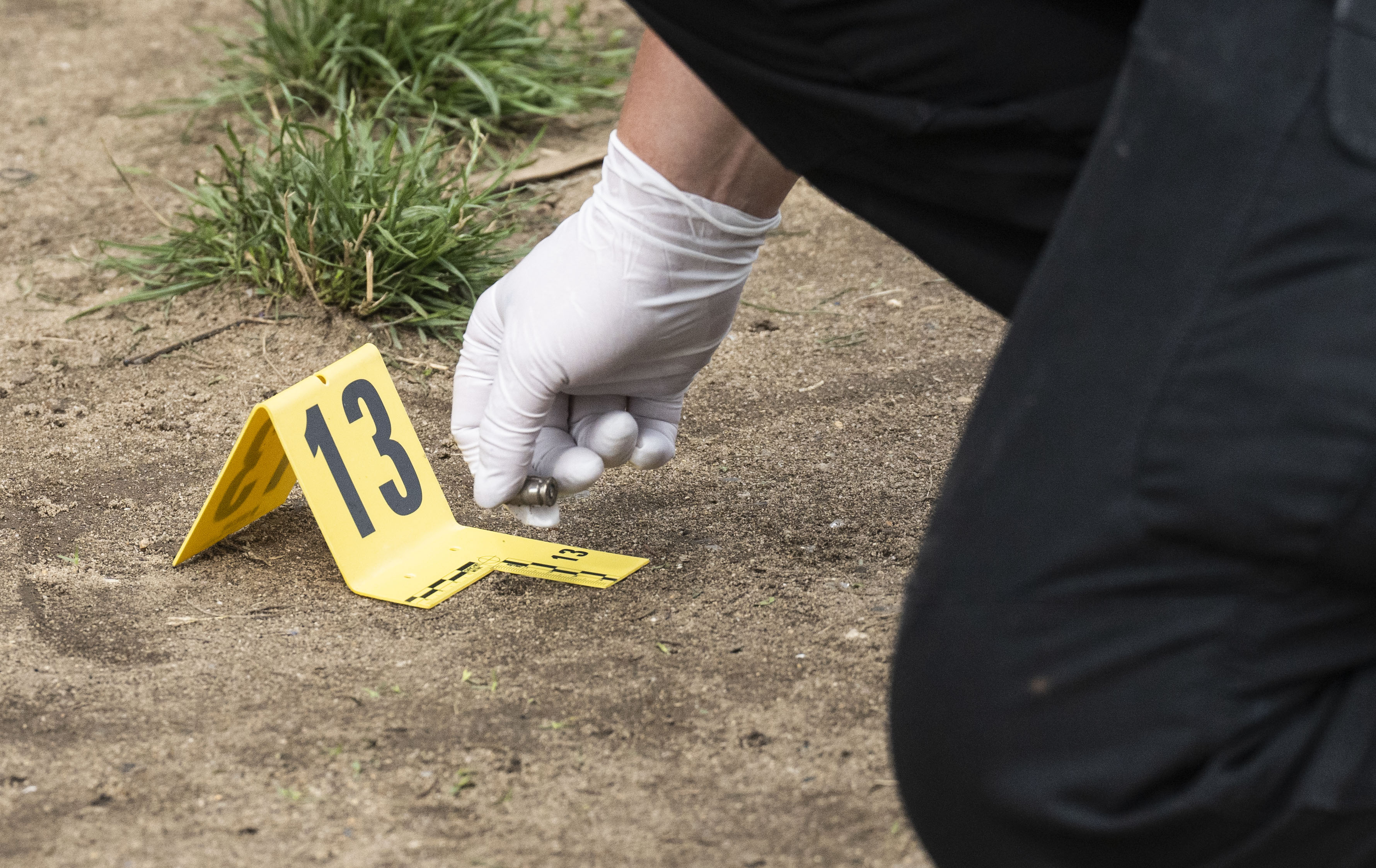 Bullet casings are marked off near Glade Court in Brooklyn following a shooting early Sunday morning, July 2.