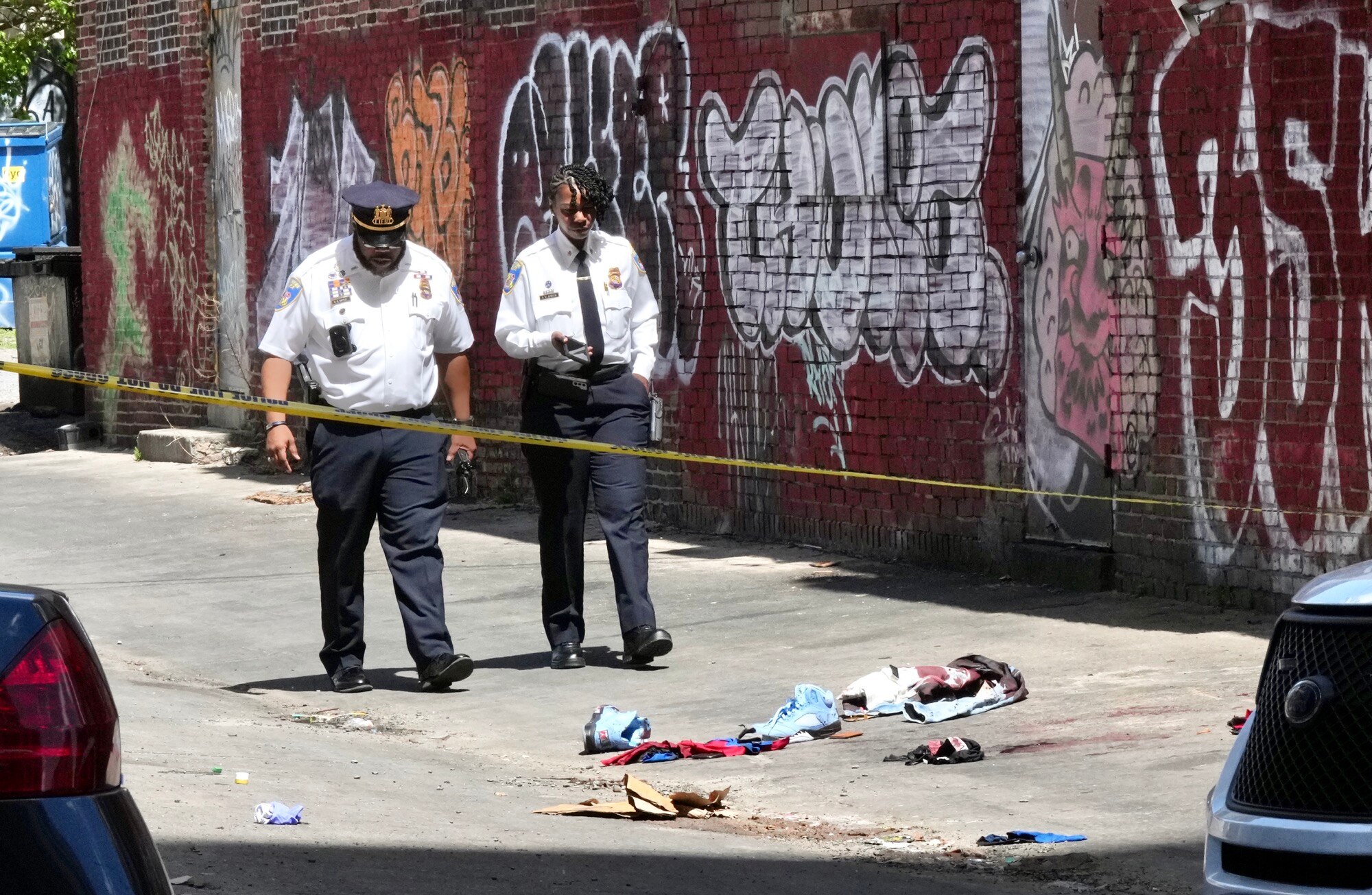 Officers investigate a quadruple shooting in Charles Village on April 17, 2023