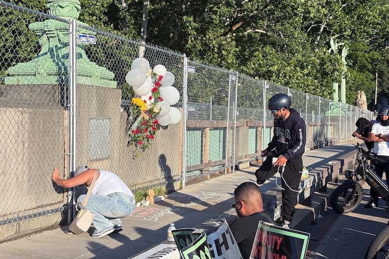 WEDNESDAY, JUNE 24, 2026 - Friends and family of Nolberto Meza write chalk messages at his memorial on the Taft Bridge Wednesday night.