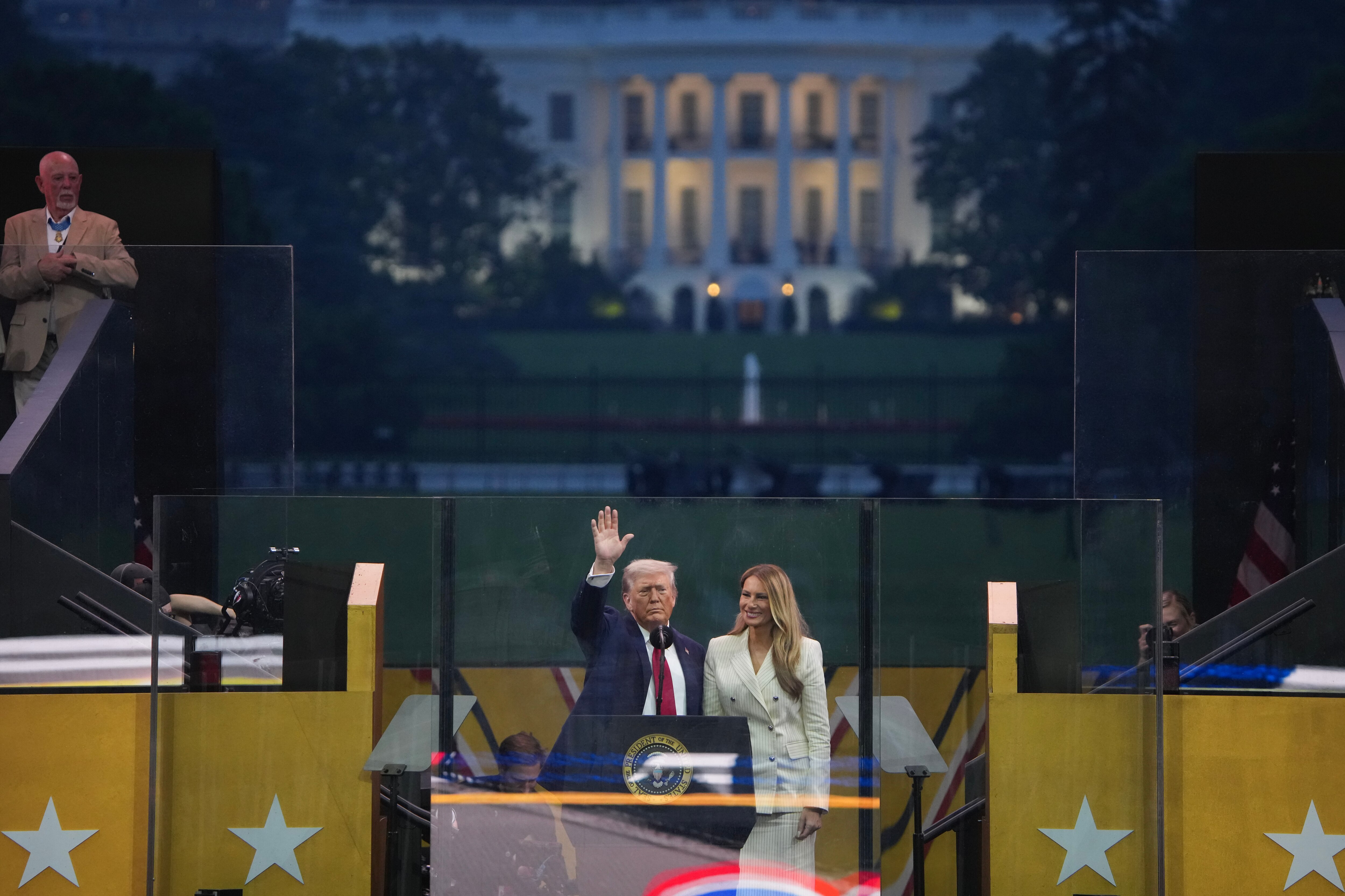 WASHINGTON, DC - JUNE 14: U.S. President Donald Trump and First Lady Melania Trump stand together at the ending of the U.S Army parade on June 14, 2025 in Washington, DC. The U.S. Army is marking its 250th birthday with the military parade including roughly 6,600 troops, 150 vehicles, and over 50 aircraft.  The parade, which coincides with President Donald Trump's 79th birthday, is designed to tell the history of the Army.