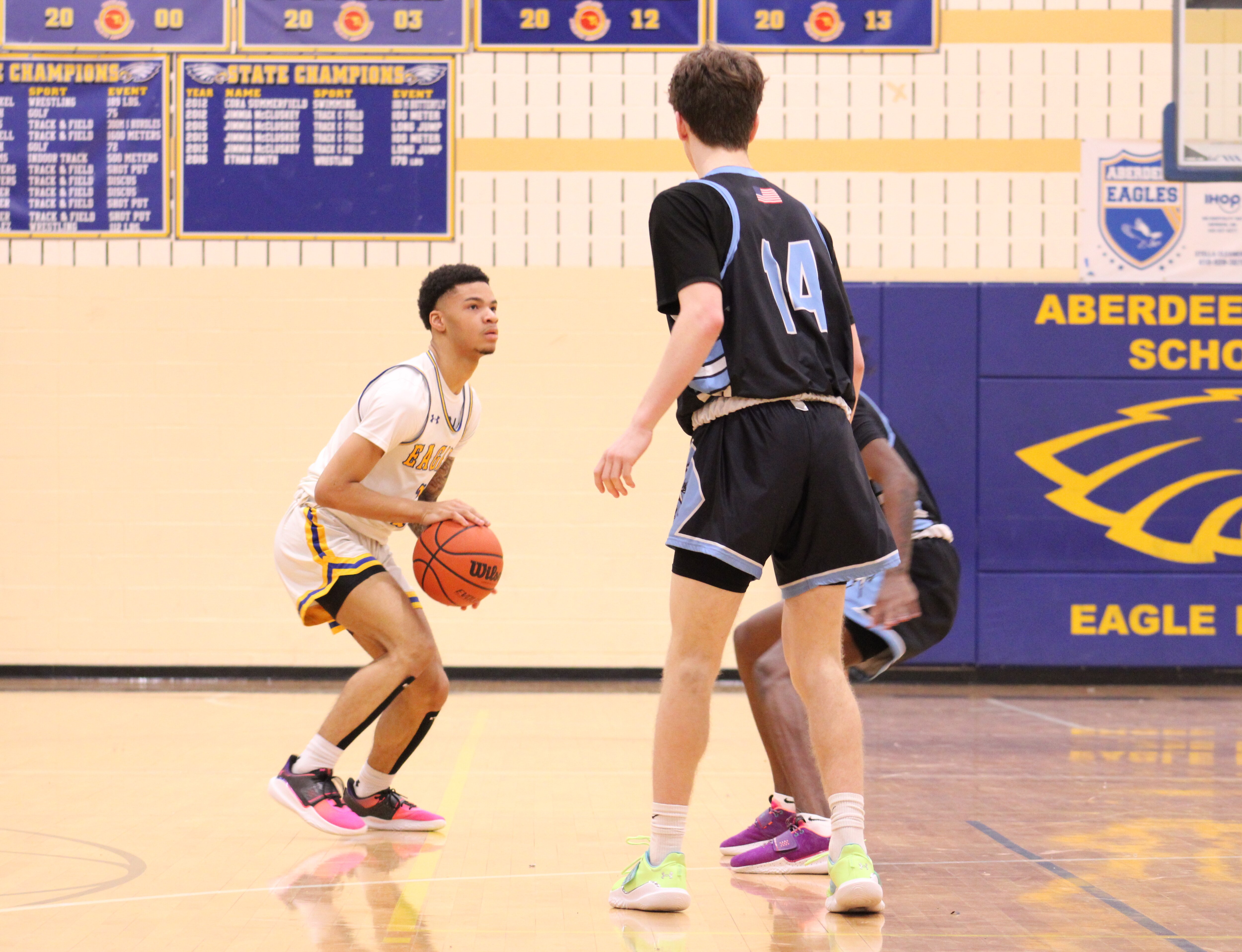 Aberdeen's Tylan Bass prepares to shoot a 3-pointer during Tuesday night's key UCBAC Chesapeake boys basketball contest with C. Milton Wright. Bass finished with a game-high 27 points as the Eagles claimed sole possession of first with a 77-68 victory in Harford County.
