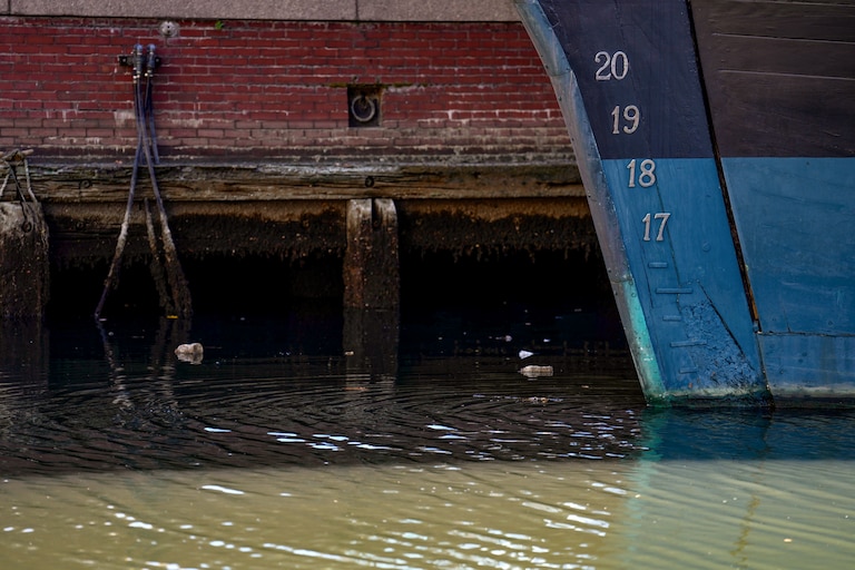 Water levels are low in Baltimore's Inner Harbor as the tide starts to come in on Thursday.