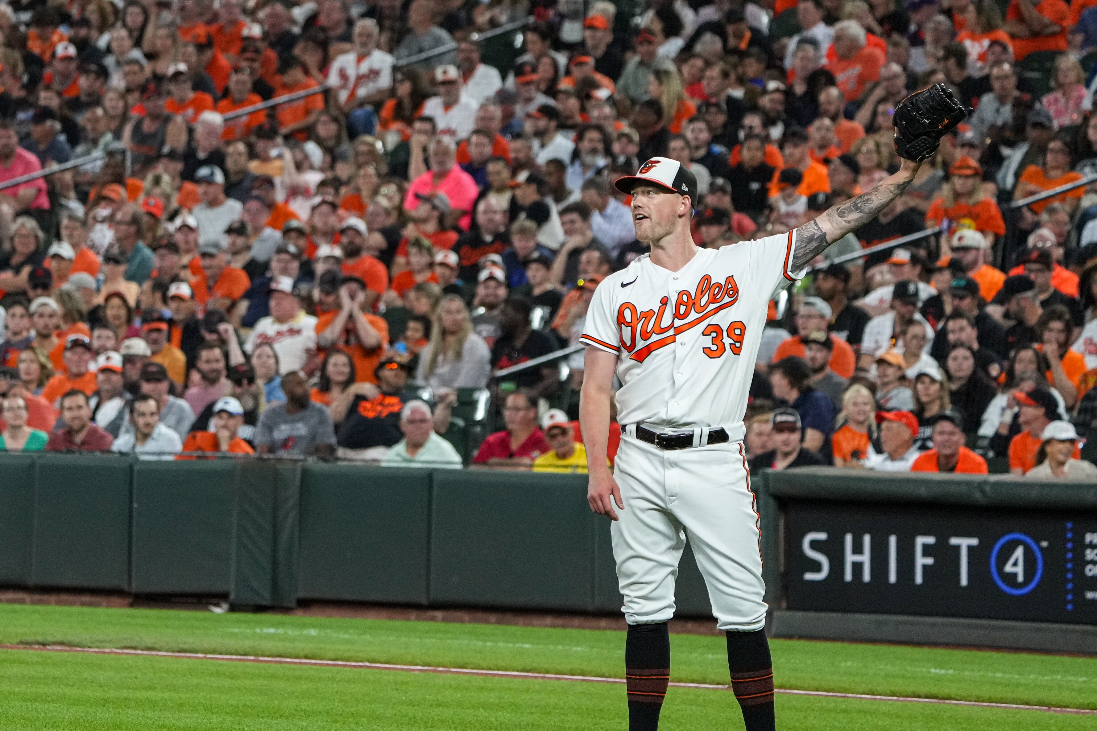 Baltimore Orioles starting pitcher Kyle Bradish (39) raised his glove to receive the ball before pitching in the third inning of a baseball game against the Tampa Bay Rays on Thursday, September 14, 2023.
