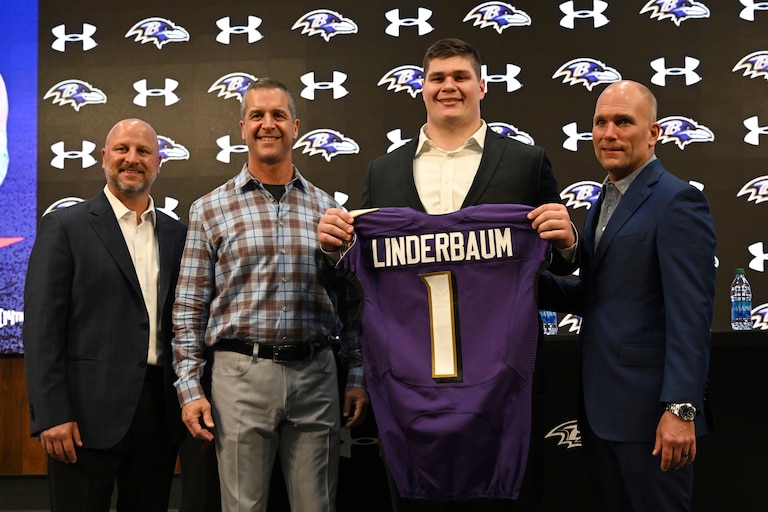 Baltimore Ravens first-round NFL football draft pick Tyler Linderbaum, second from right, stands with head coach John Harbaugh, second from left, director of player personnel Joe Hortiz, left, and executive vice president and general manager Eric DeCosta, right, during a news conference Friday, April 29, 2022, in Owings Mills, Md.