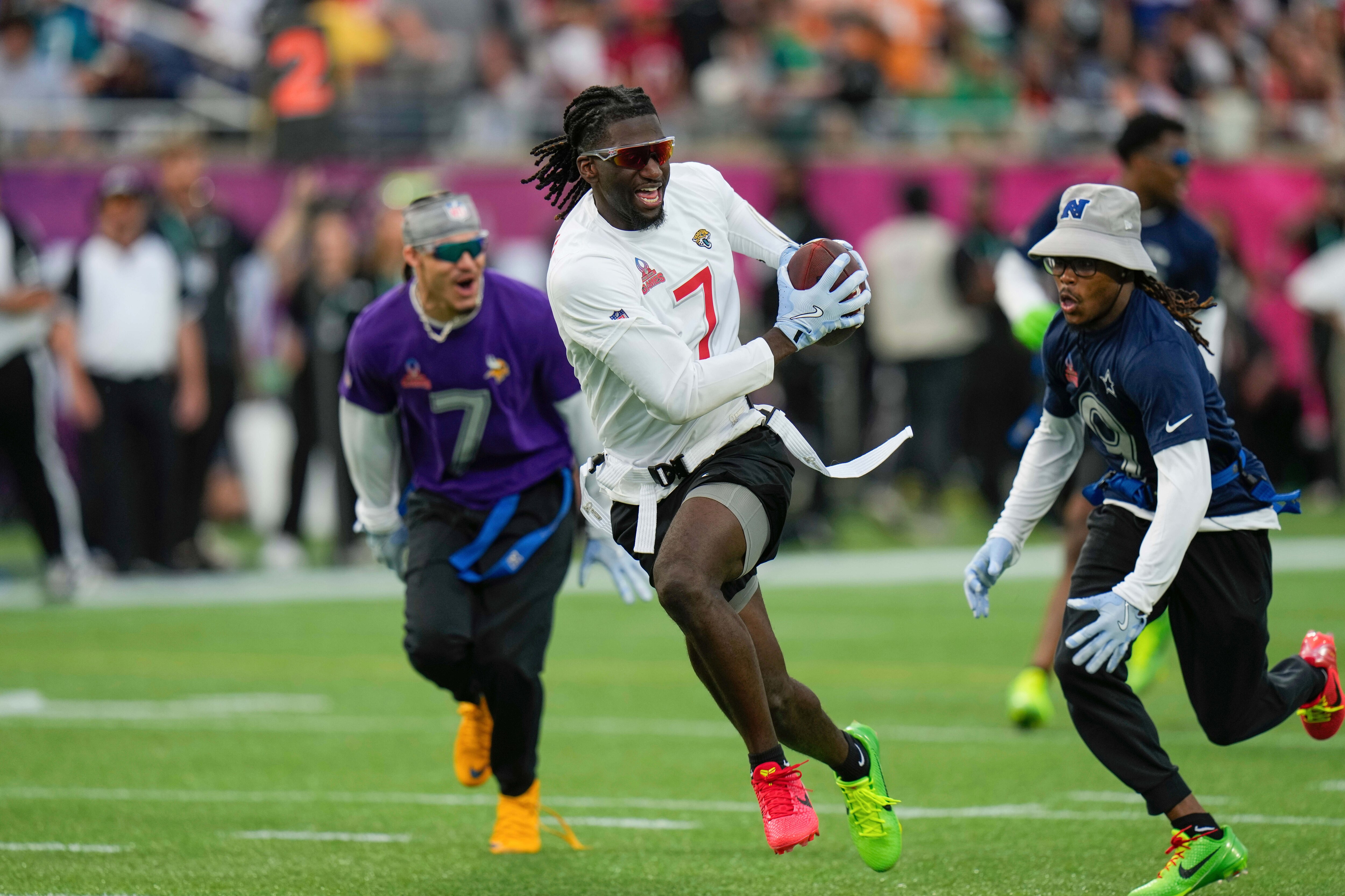 FILE - AFC wide receiver Brian Thomas Jr. (7), of the Jacksonville Jaguars, runs away from NFC return specialist KaVontae Turpin, of the Dallas Cowboys, right, during the flag football event at the NFL Pro Bowl, Sunday, Feb. 2, 2025, in Orlando.