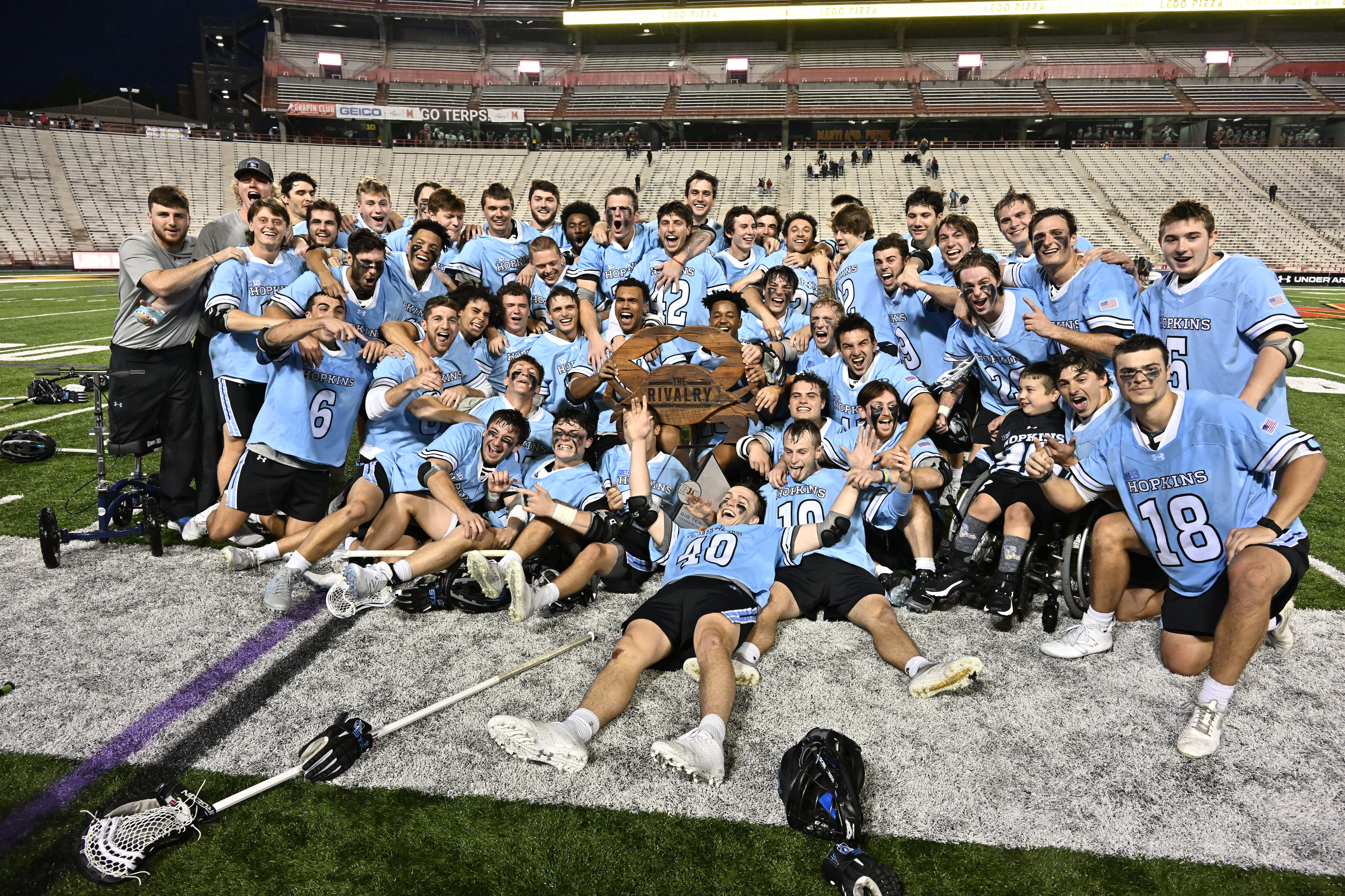 Members of the Johns Hopkins lacrosse team celebrate after beating Maryland in College Park. (Photo courtesy of Johns Hopkins Athletics.)