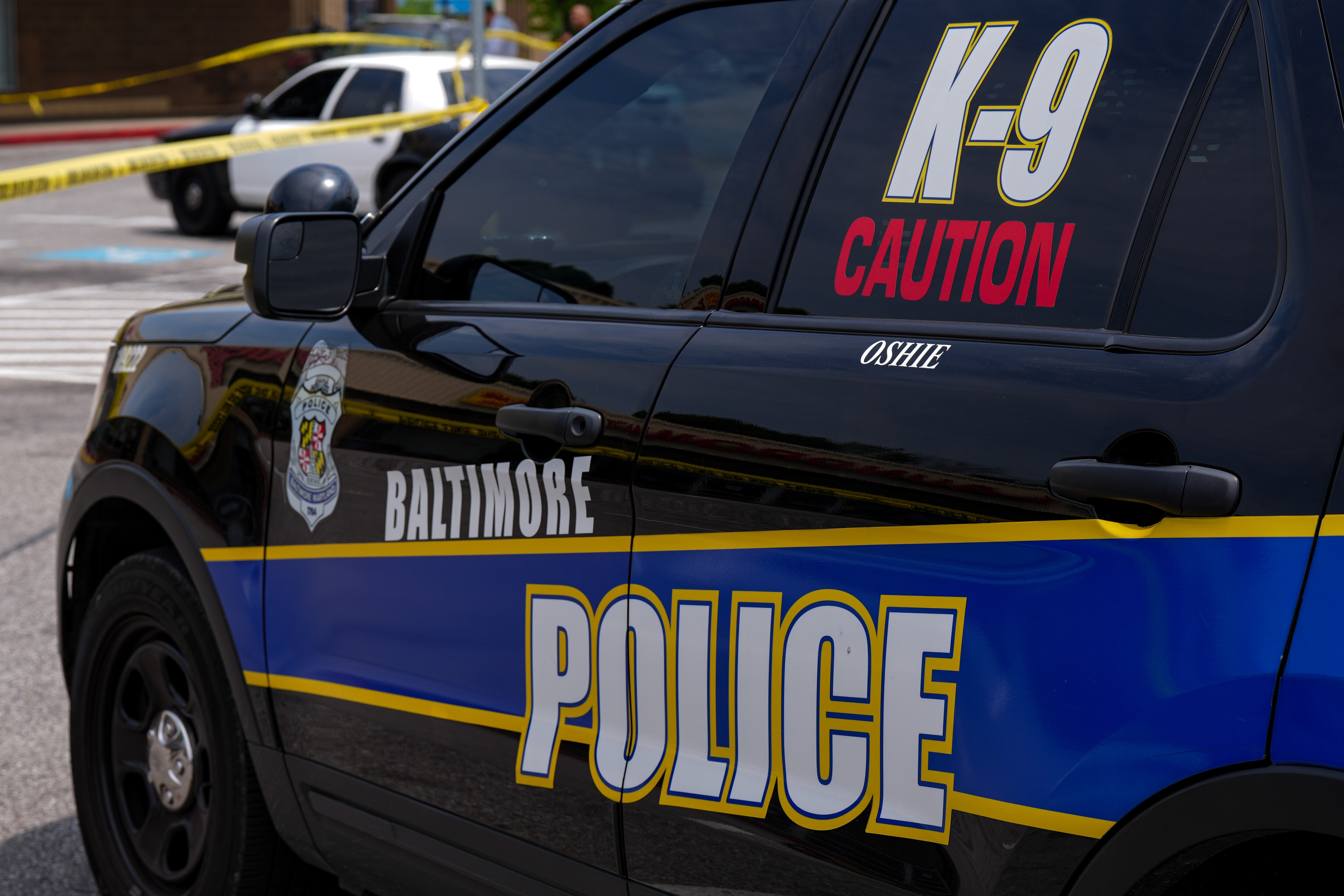 6/22/22—Police investigate a crime scene where three men were shot in a Northeast Baltimore shopping center Wednesday morning.