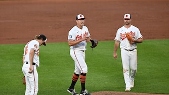 Orioles pitcher Trey Gibson, center, pauses before exiting the game against the Seattle Mariners in the fifth inning.