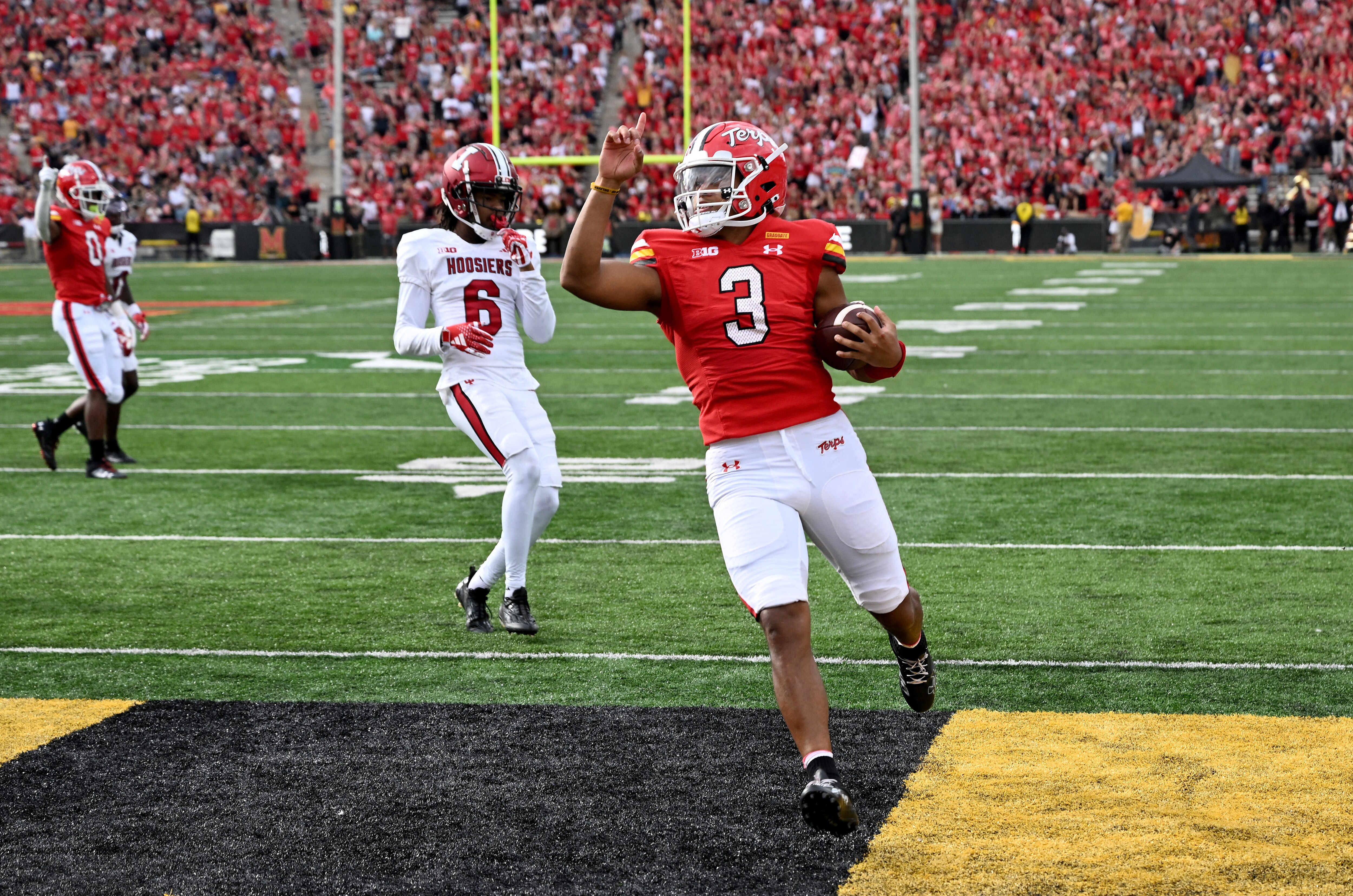 Taulia Tagovailoa, who passed for five touchdowns in the game, scores on a run in the first quarter of Maryland's 44-17 win at Indiana.
