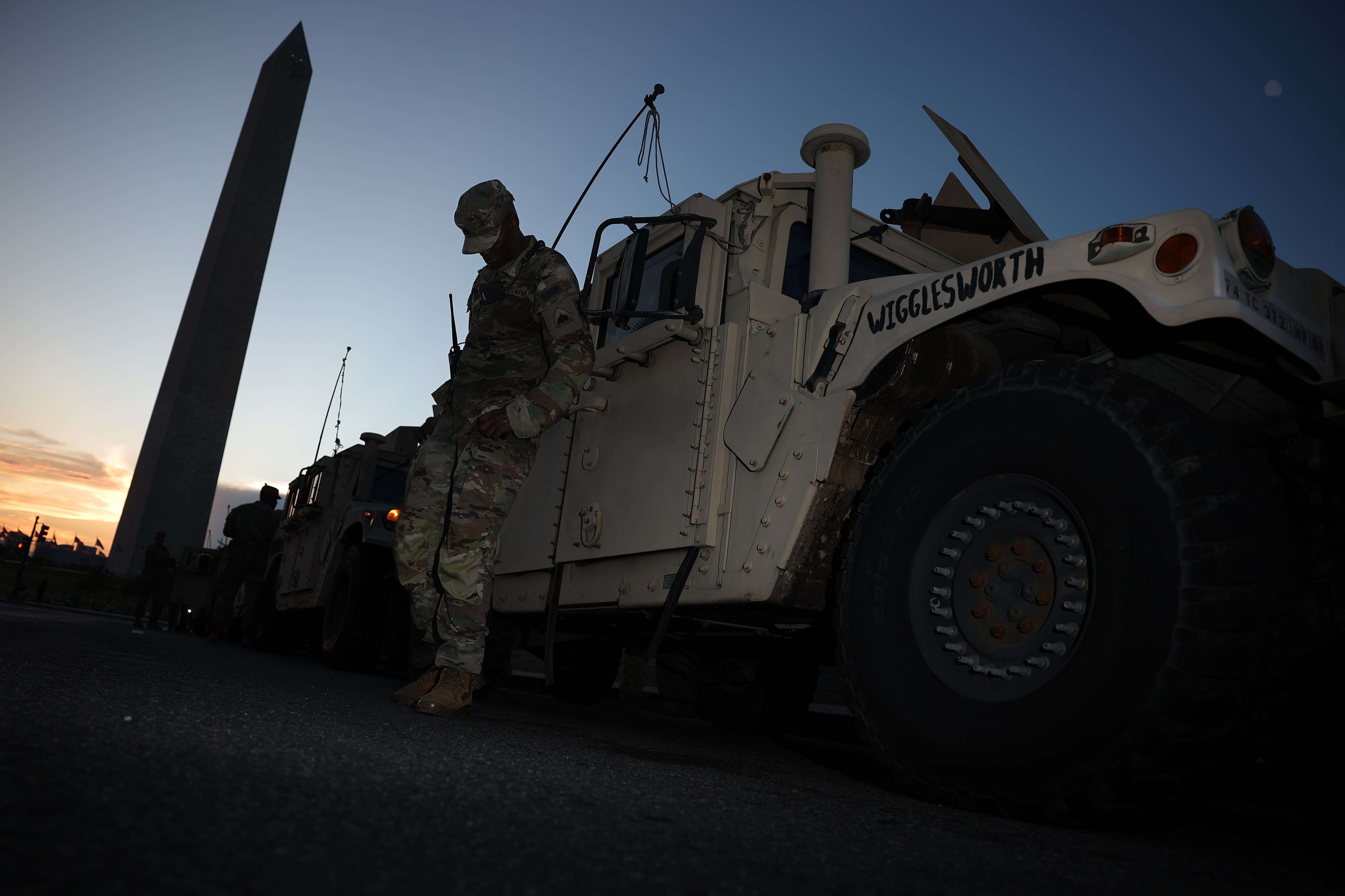 WASHINGTON, DC - AUGUST 12: A member of the DC National Guard waits with his unit near the Washington Monument on August 12, 2025 in Washington, DC. The Trump administration has initiated a federal takeover of DC police and mobilized the DC National Guard, saying the moves are necessary to restore order in the city.