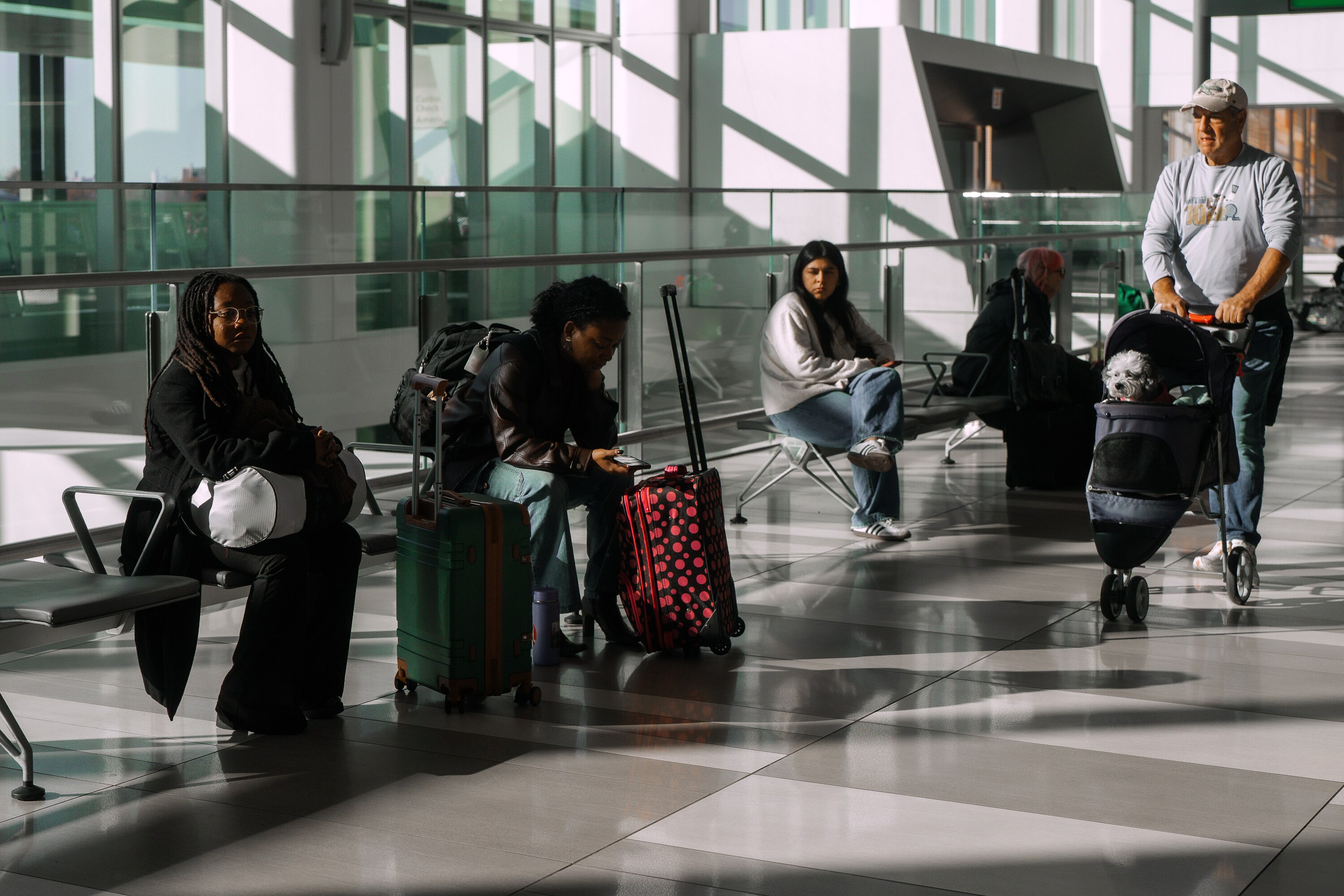 Travelers wait at LaGuardia International Airport on Saturday, Nov. 8, 2025, in New York. (AP Photo/Olga Fedorova)