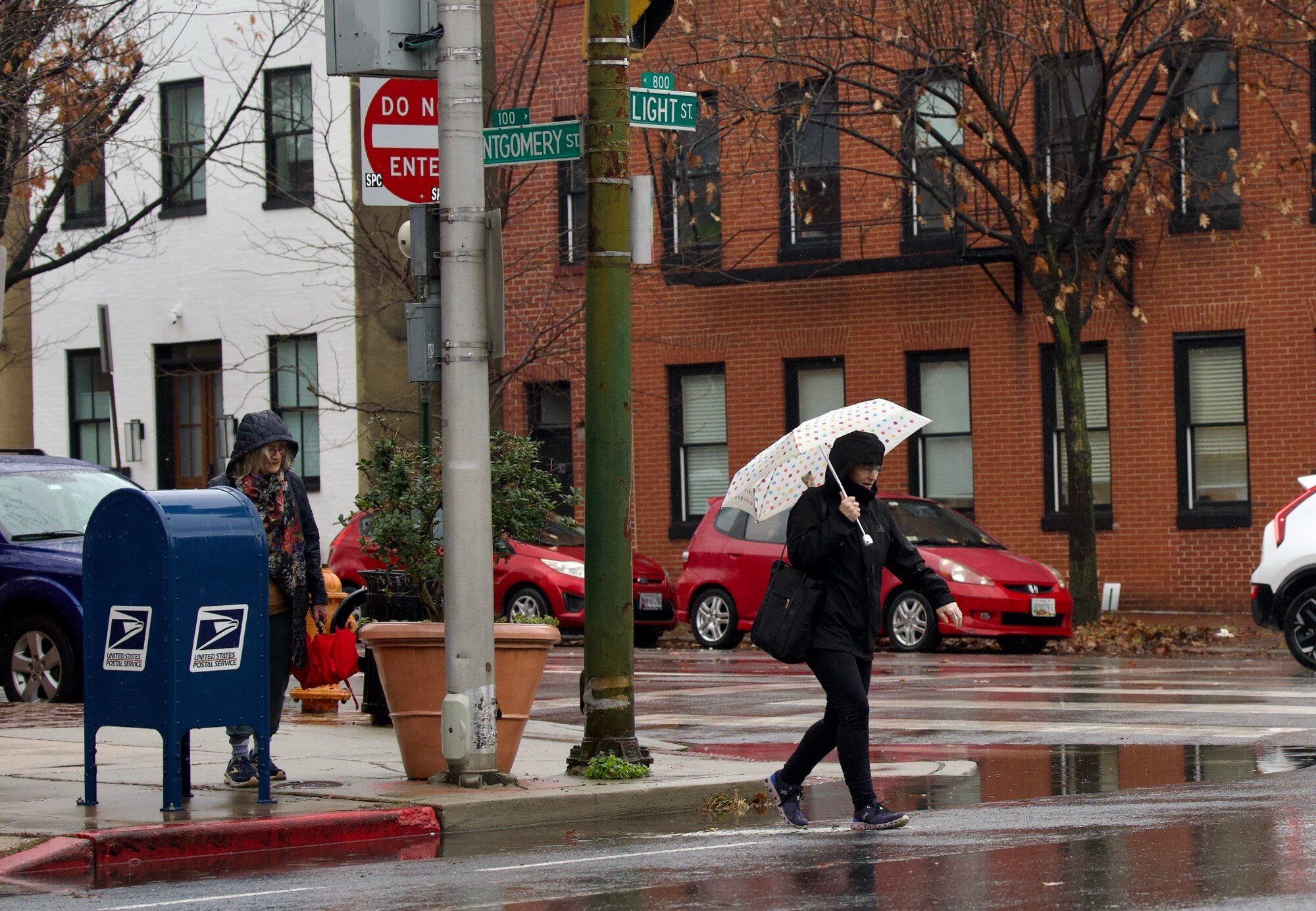 Residents of South Baltimore brave the downpour on December 11, 2024.