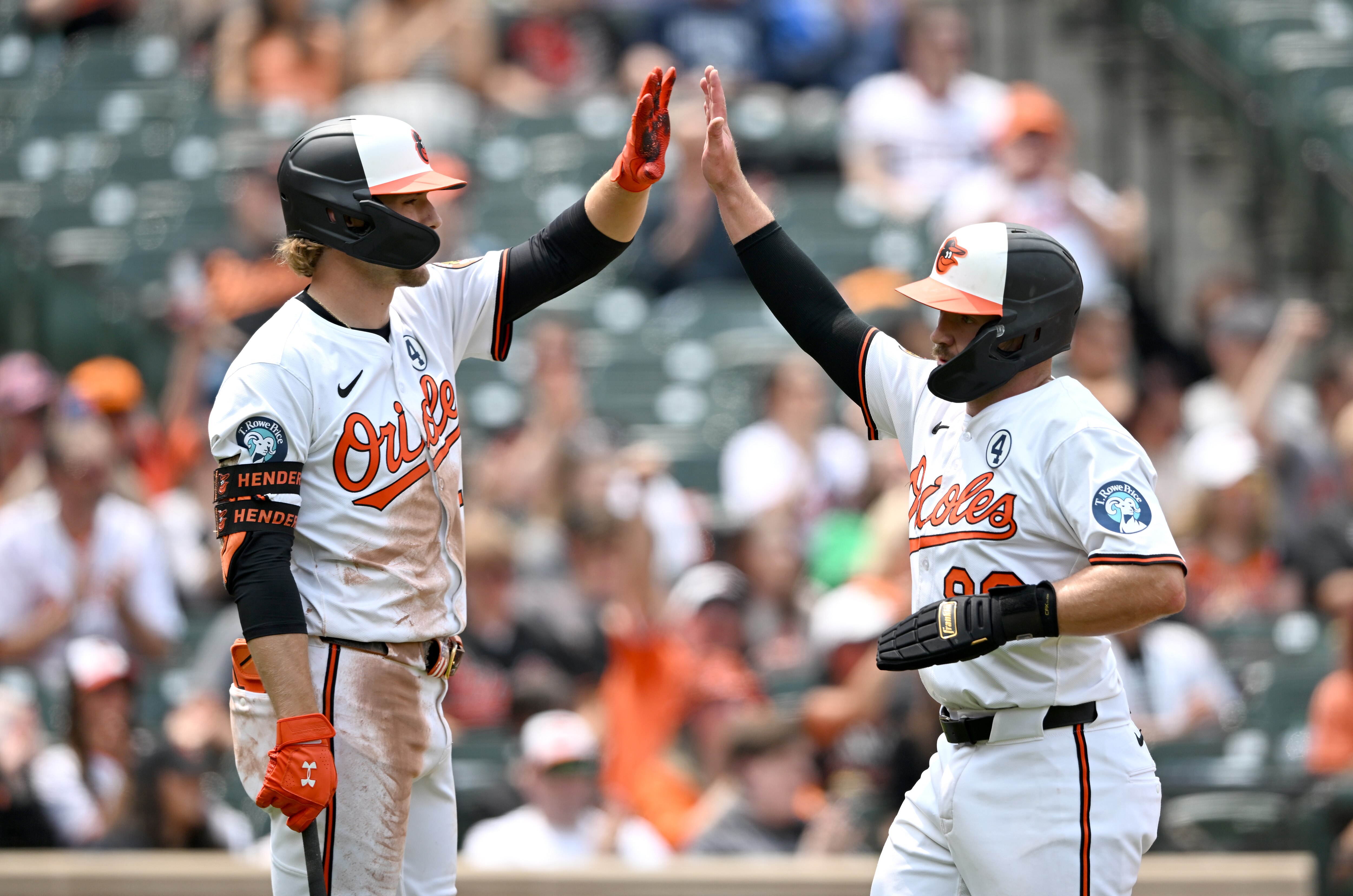Maverick Handley high-fives Gunnar Henderson after scoring in the third inning of the Orioles’ 3-2 win over the Chicago White Sox on Sunday.