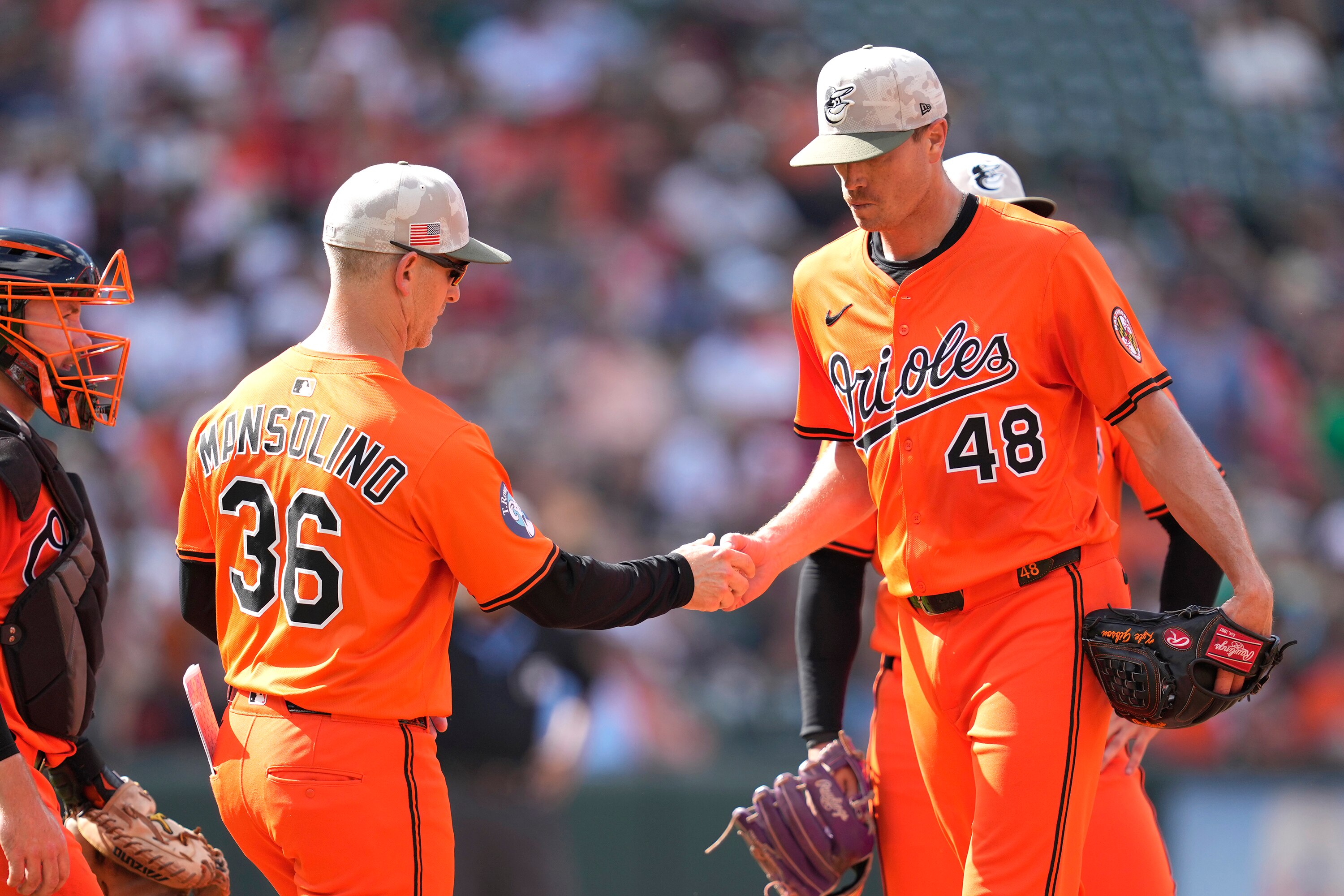 Interim Orioles manager Tony Mansolino takes the ball from Kyle Gibson in the top of the first inning Saturday at Camden Yards.