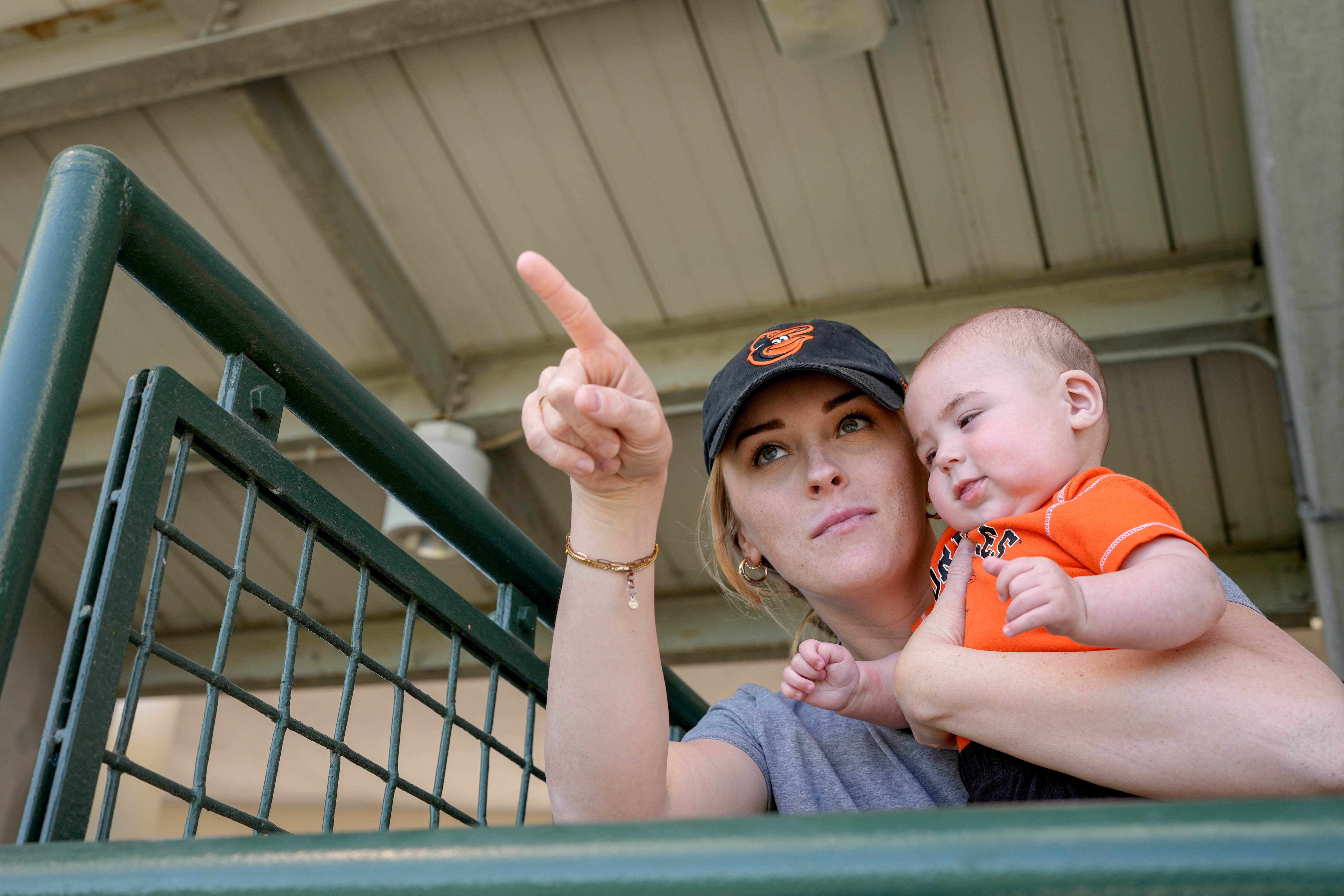 Jessie Webb and her 4-month-old son, Jonah, watch her husband, Orioles pitcher Nate Webb, throw a live bullpen session during spring training in Sarasota, Fla.