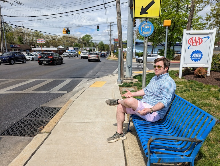 Alderman Brooks Schandelmeier sits on a bus stop bench on Forest Drive at Tyler Avenue during a tour of the busy Annapolis roadway.