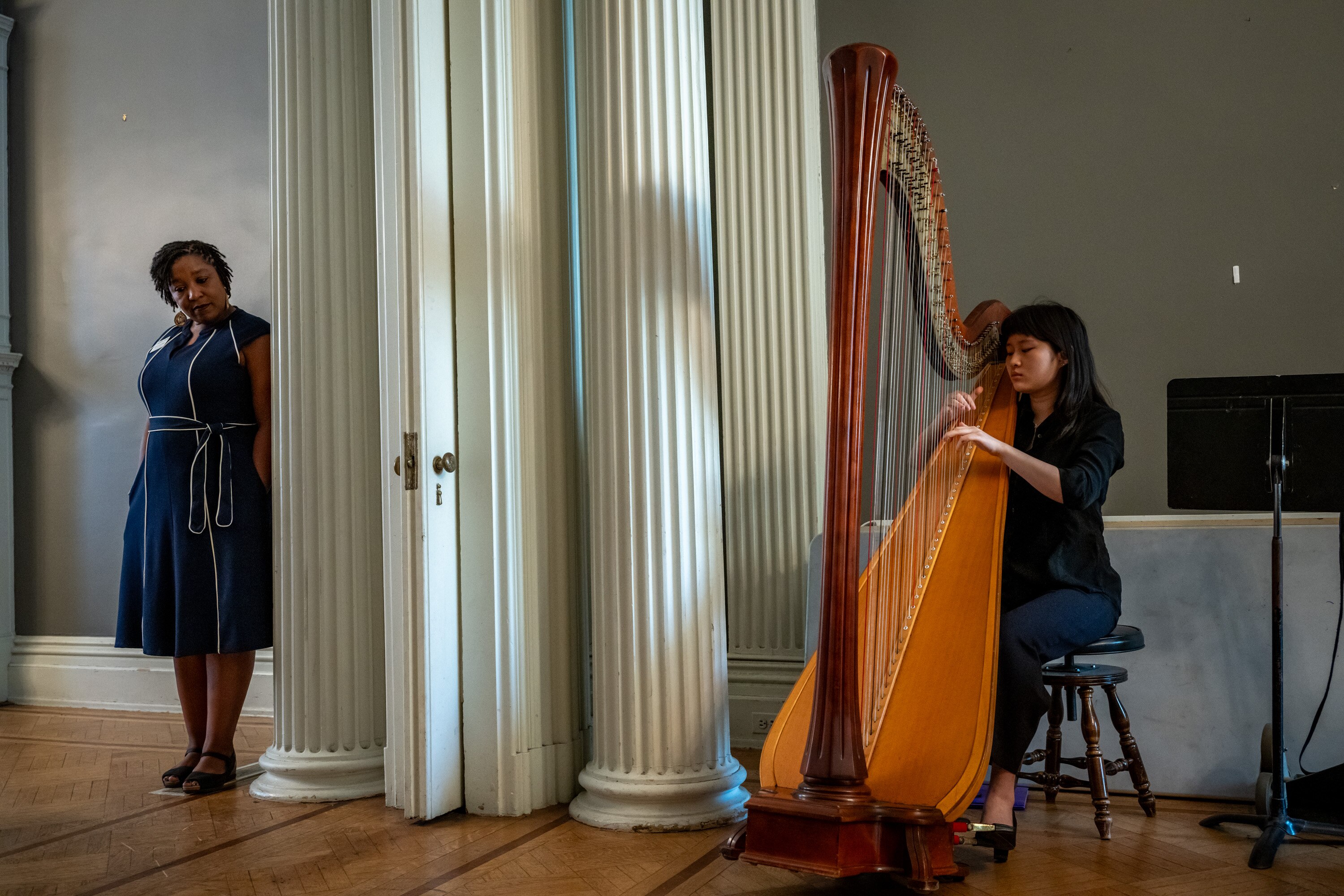 Rosiland “Roz” Cauthen, left, executive director and principal of the Baltimore School for the Arts, listens as graduating senior Skye Chng-Lim, 18, performs for a group of school supporters. 