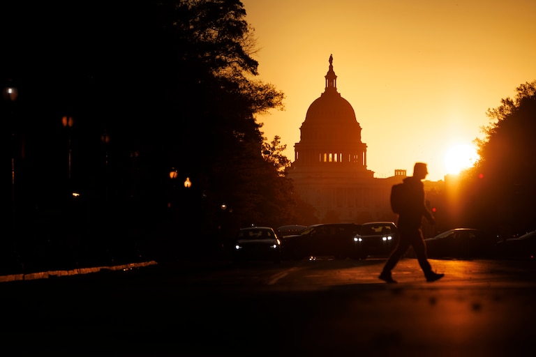 WASHINGTON, DC - NOVEMBER 5: A pedestrian walks along Pennsylvania Avenue near the U.S. Capitol during sunrise on November 5, 2025 in Washington, DC. The record for longest shutdown in the U.S. Government was broken Wednesday as it entered its 36th day.