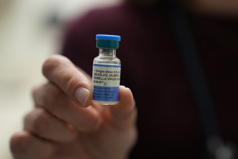 FILE - Dr. Jessica Early holds a vial of the combination measles, mumps and rubella vaccine at Prisma Health Pediatrics in Greer, S.C., March 18, 2026.