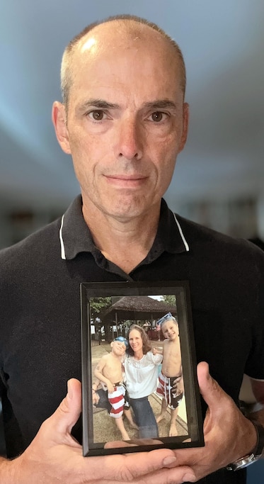 Daniel Langenkamp holds a photo of his late wife, Sarah, and their two sons.