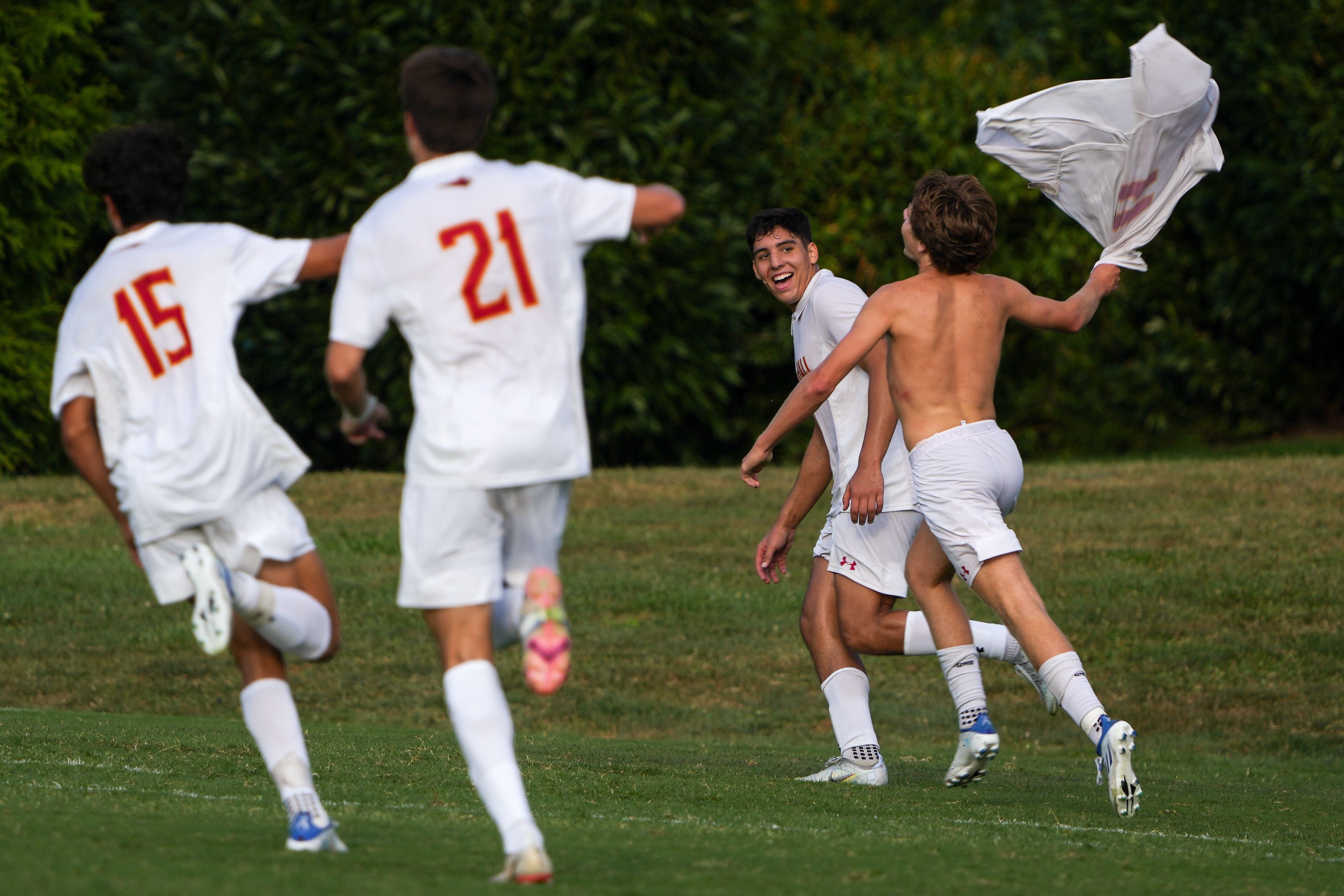 Calvert Hall’s Benjamin Madore (11) removes his shirt and celebrates with his team after they beat McDonogh in overtime of a boys soccer game on 8/26/22. Calvert Hall defeated McDonogh, 1-0, in overtime.
