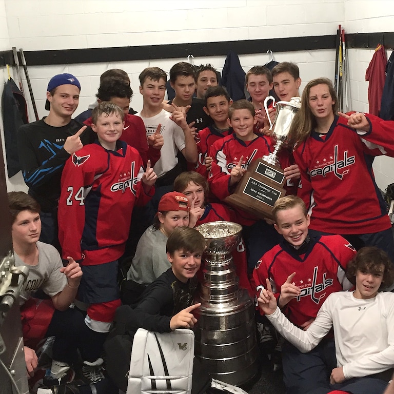Eden Lacey celebrates winning the AAA Challenge Cup with the rest of the Little Washington Capitals 2002 Bantam Major travel hockey team.