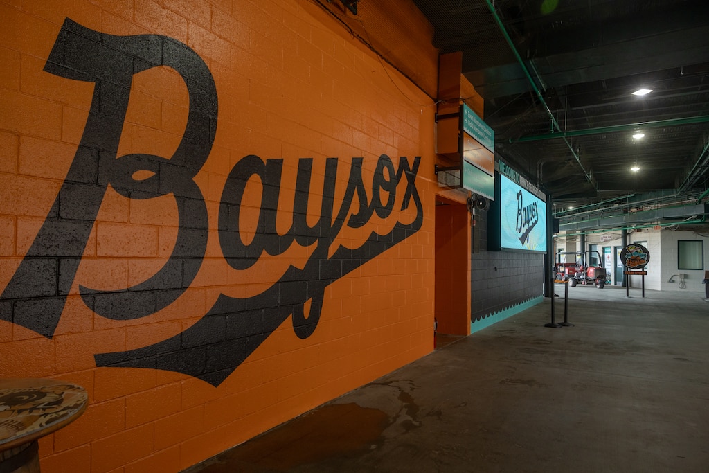 A Chesapeake Baysox mural and tv screens greet visitors inside the front gate of the Prince George's Stadium.