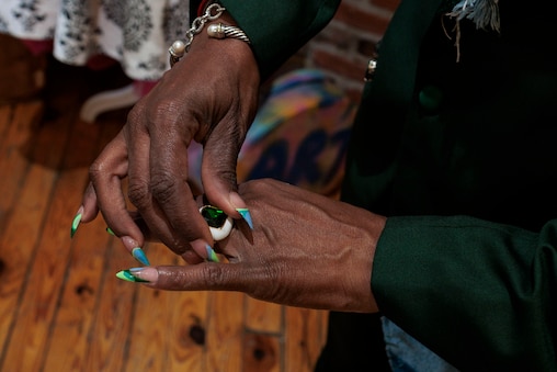 Saturday, April 11, 2026, in Baltimore — Shelonda Stokes, President of the Downtown Partnership of Baltimore and Executive Director of the Downtown Management Authority, tries on accessories during a suit fitting by designer Natalie Karyl.