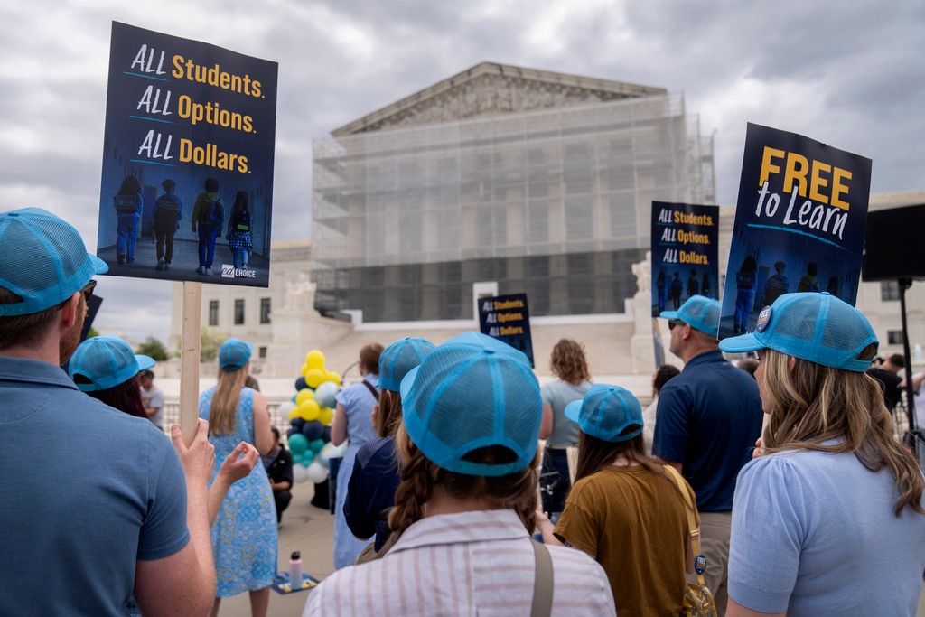 Supporters of charter schools rally outside of the Supreme Court.