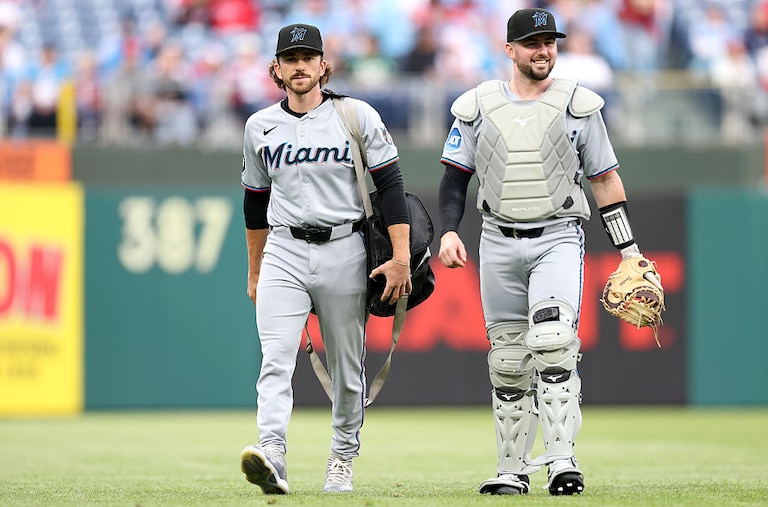 Joe Singley, Catching Coach/Assistant Catching Director/Bullpen Catcher, walks with Liam Hicks of the Miami Marlins before a game against the Philadelphia Phillies in April.