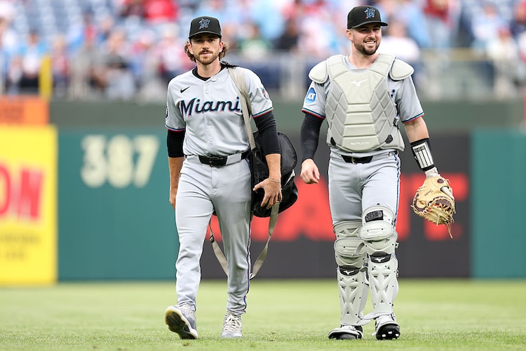 Joe Singley, Catching Coach/Assistant Catching Director/Bullpen Catcher, walks with Liam Hicks of the Miami Marlins before a game against the Philadelphia Phillies in April.
