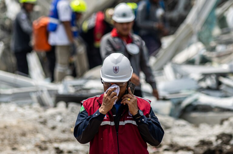BANGKOK, THAILAND - MARCH 29: Rescue workers work on the scene of a building collapse in Bangkok's Chatuchak neighborhood on March 29, 2025 in Bangkok, Thailand. In the aftermath of the 7.3 magnitude earthquake that struck Myanmar, Bangkok finds itself in an unprecedented state of paralysis in Friday evening. The tremors, felt strongly in the Thai capital, transformed the usually vibrant city into a maze of motionless vehicles and anxious faces. As rescue efforts continue at a collapsed building site, the city's arteries remain clogged, with millions of residents caught between the urge to flee and the impossibility of movement, painting a picture of a metropolis frozen in time by nature's sudden fury. (Photo by Lauren DeCicca/Getty Images)