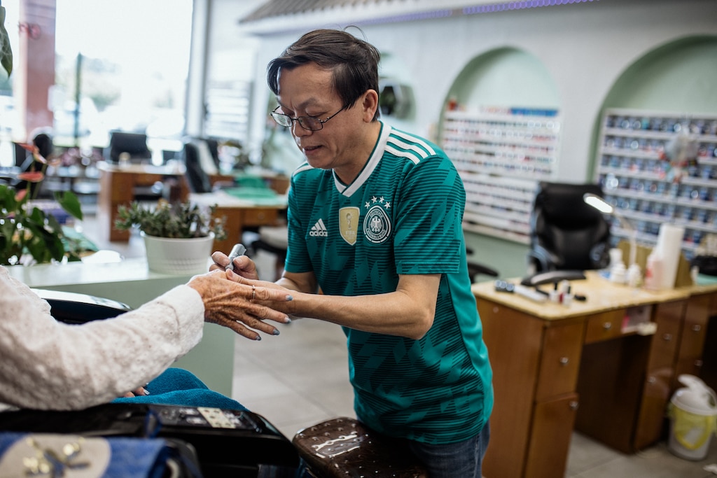 HAGERSTOWN, MD - July 22, 2026: Danny Hoang, 56, works alone at the Nail Palace and Spa in Hagerstown, Maryland on July 22, 2026. He owns the nail salon with his wife, Melissa, who was deported to Vietnam last November. Since then, he has been working by himself and working long hours to provide for his family. Rosem Morton for The Baltimore Banner