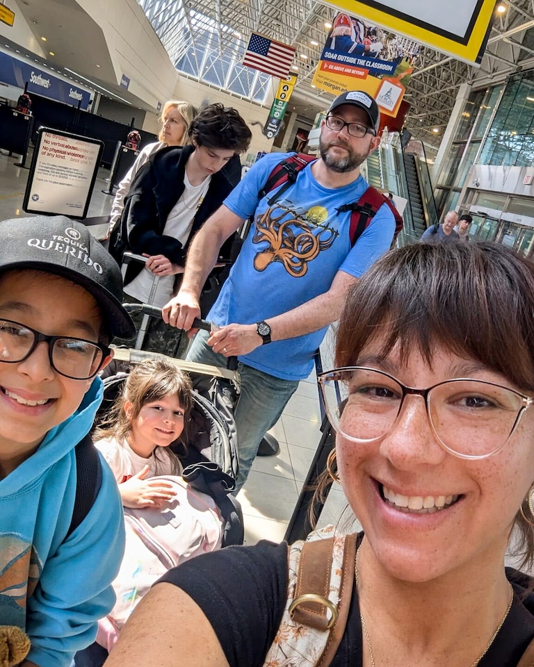 Jessica Carr and her family waiting in line Thursday as they depart for their spring break trip