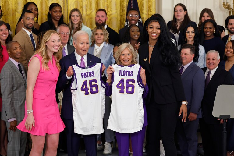 WASHINGTON, DC - MAY 26: U.S. President Joe Biden and first lady Jill Biden pose for photographs with co-captains Emily Ward (L) and Angel Reese during a celebration for the Louisiana State University NCAA Division I women's basketball national championship team in the East Room of the White House on May 26, 2023 in Washington, DC. Under the leadership of head coach Kim Mulkey, the LSU Tigers defeated Iowa 102-85 to win their first national championship.